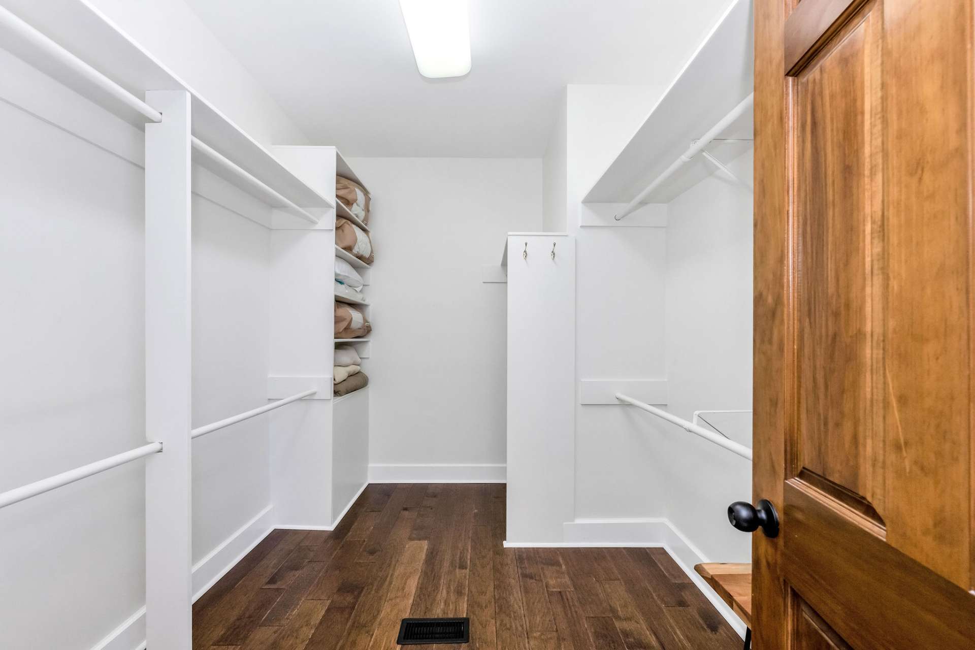 A spacious walk-in closet with shelving.
