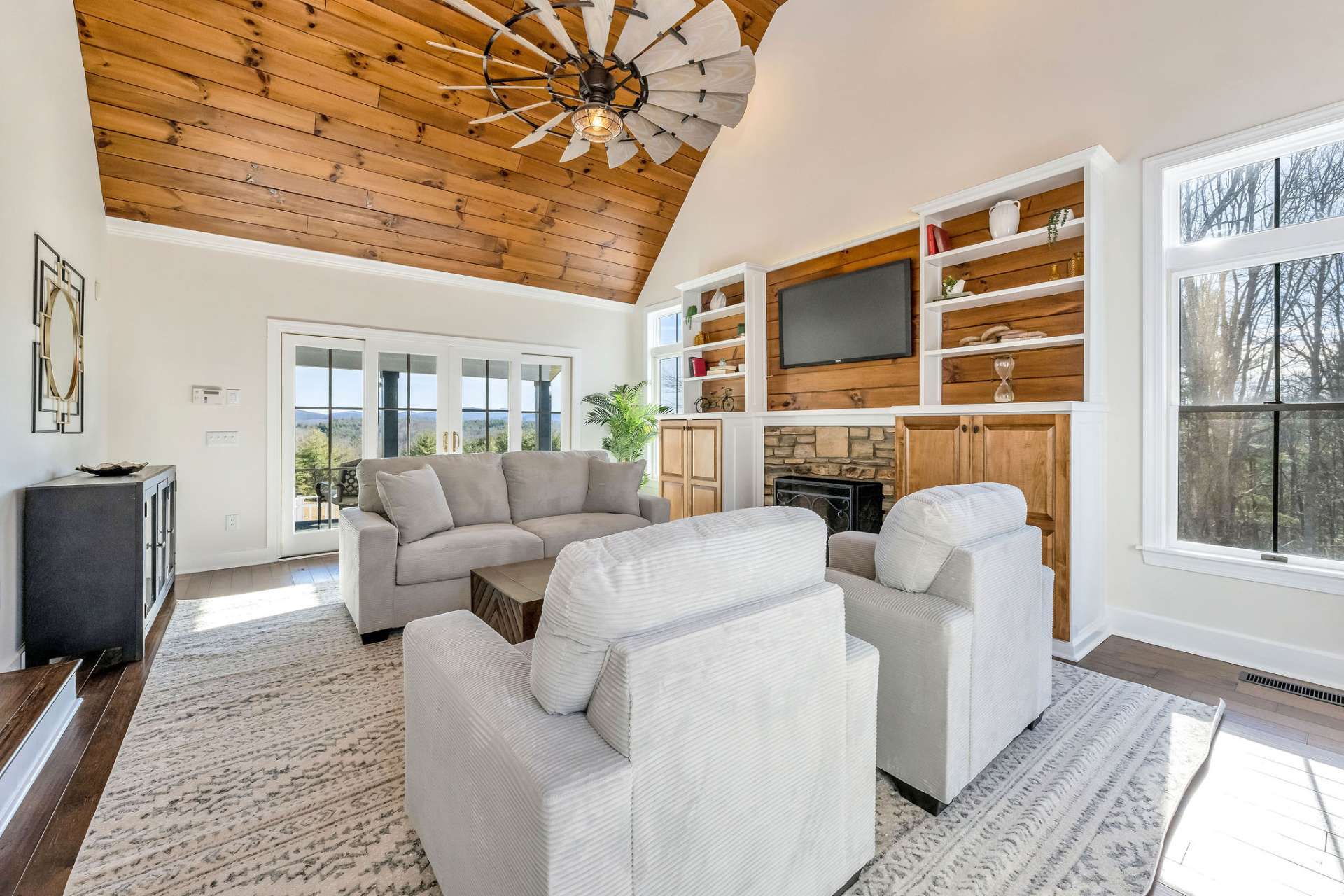 Large windows showcase the outdoors in every season.