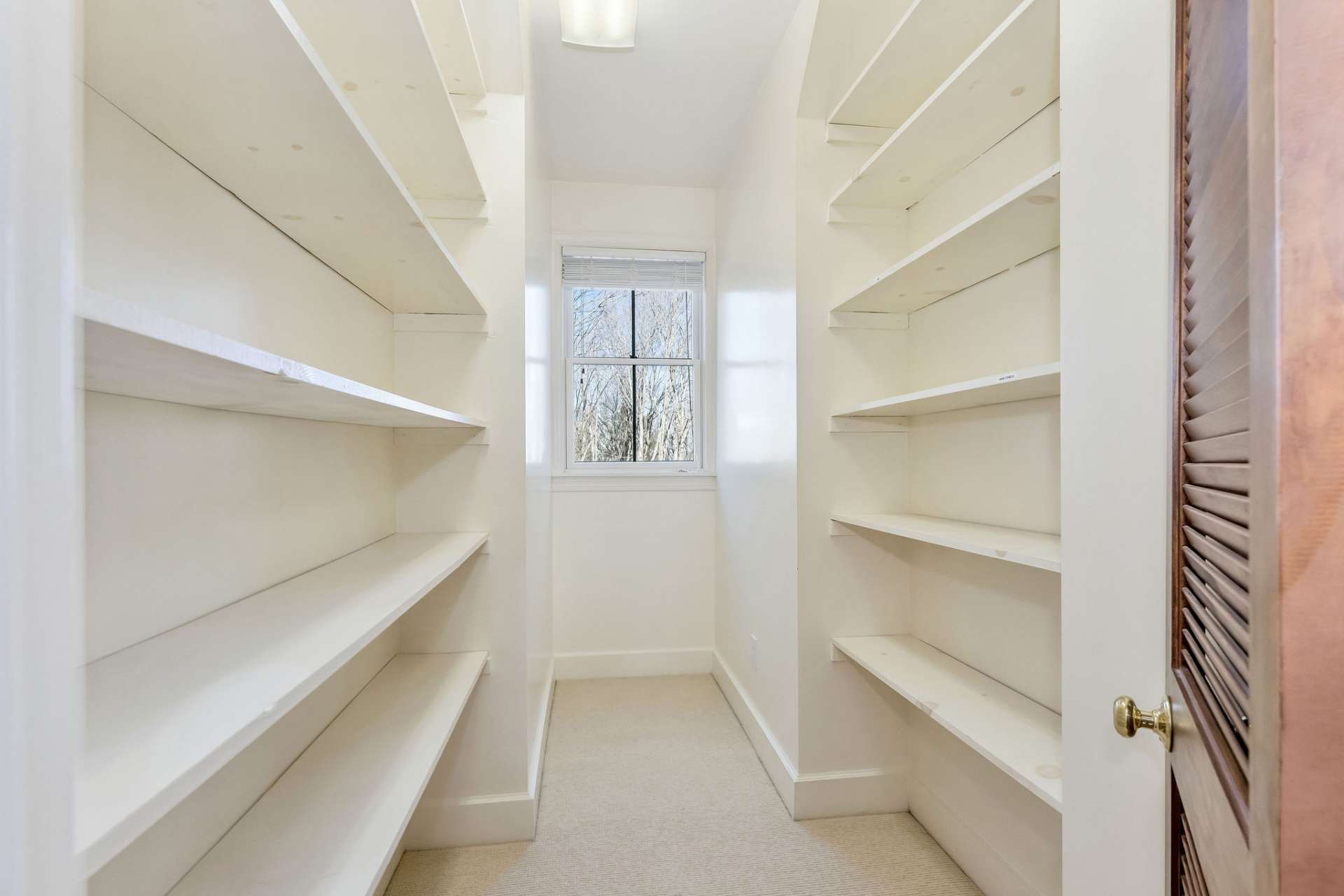 An extremely special feature is the hall storage closet with a window to add natural light to the space.