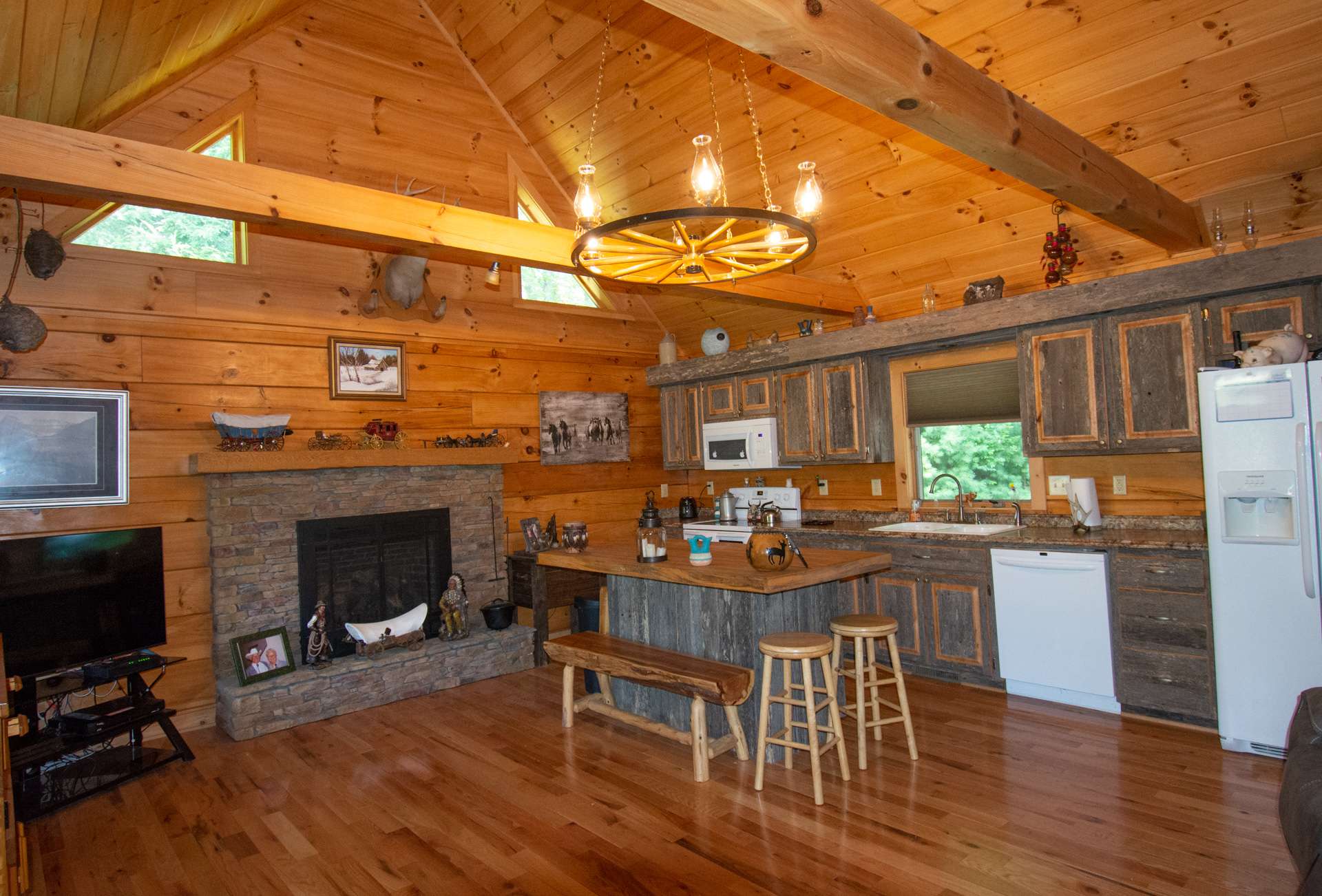 Features include a spacious vaulted great room with wood floors, exposed beams, stone fireplace with gas logs, and...