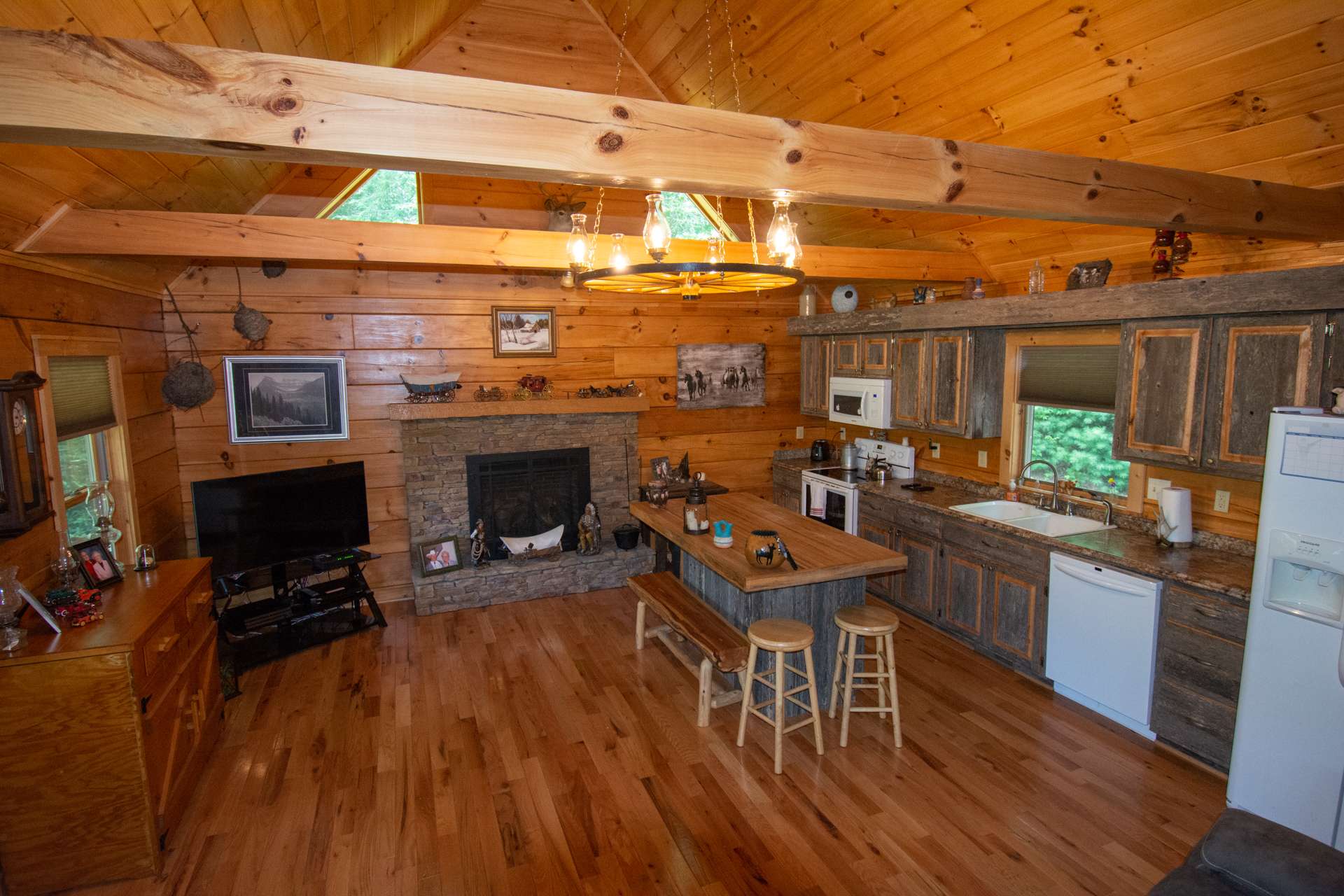 ...rustic kitchen cabinetry and island with bar seating and storage underneath.