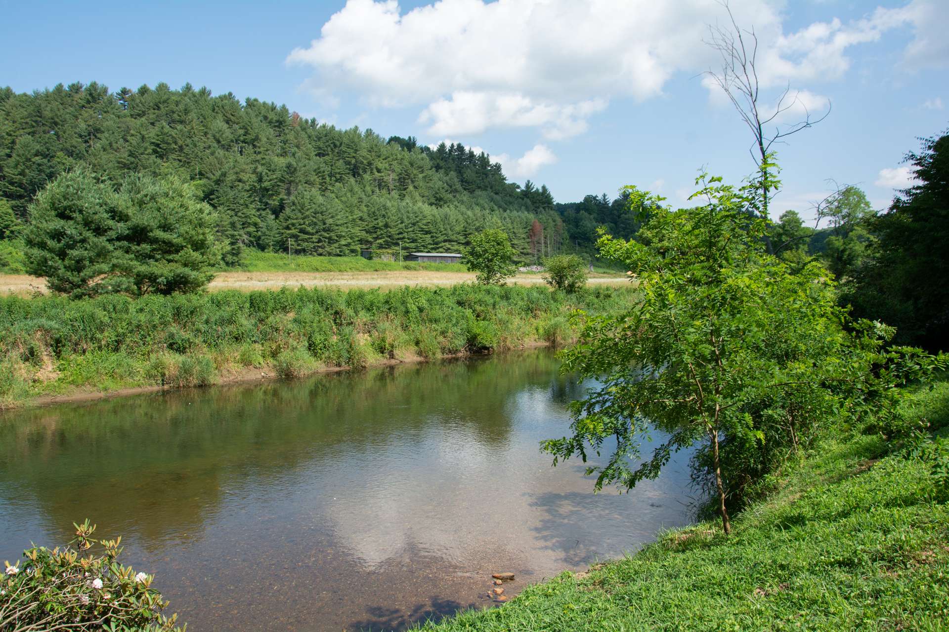 Great opportunity for a vacation home or vacation rental investment with almost 100 feet of frontage on the New River where the water is shallow providing a great spot to cool off/swim on a hot summer day.