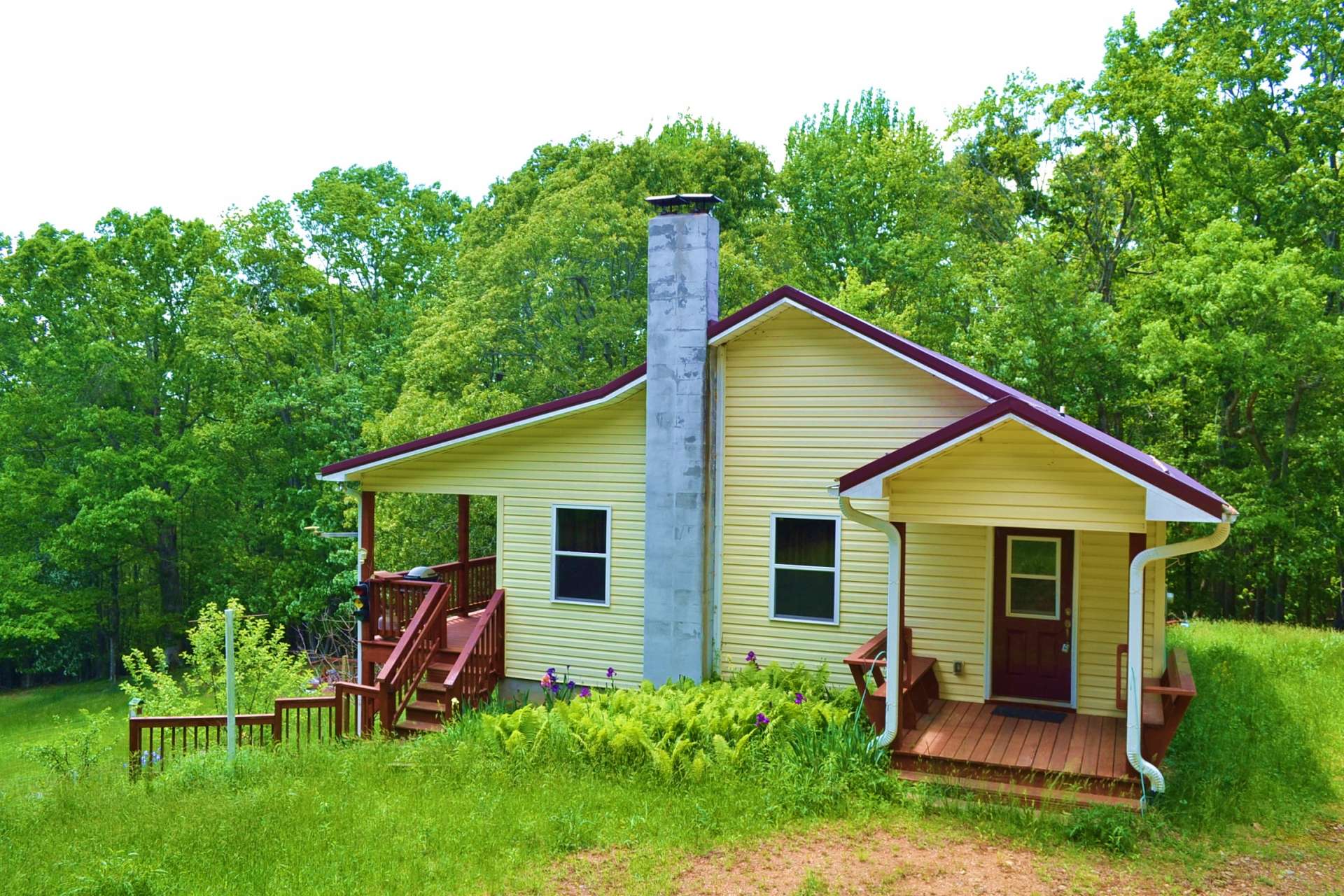 A sweet covered side porch welcomes you home.