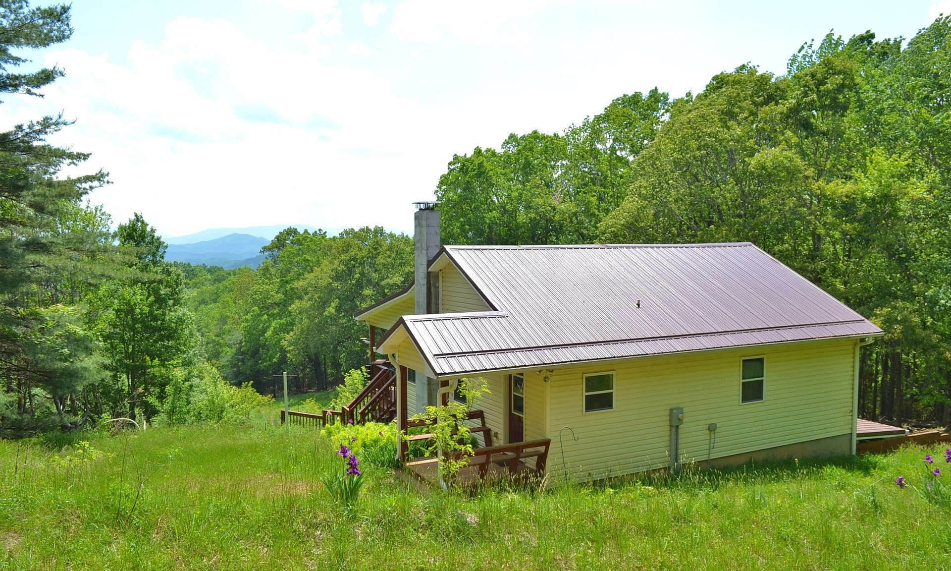 Enjoy Private mountain living and fabulous long range layered views with this sweet 2-bedroom, 2-bath mountain cottage nestled among 6.95 acres in Kindrick Mountain, a private gated community in the Mouth of Wilson area of Grayson County of Southwest Virginia.