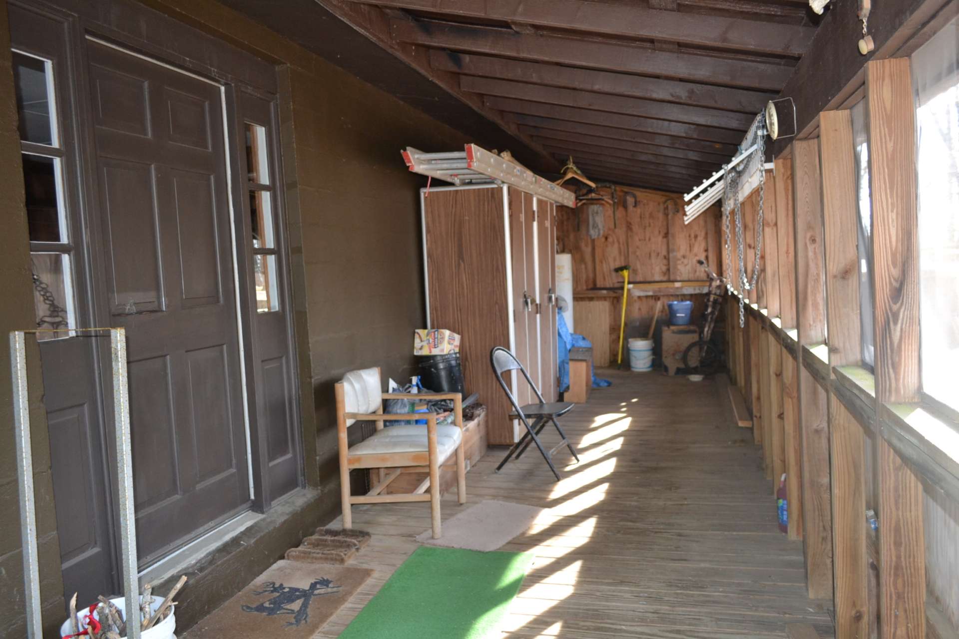 You will enter the cabin from the enclosed covered porch that provides plenty of storage space and expanding the living space during the warmer months.