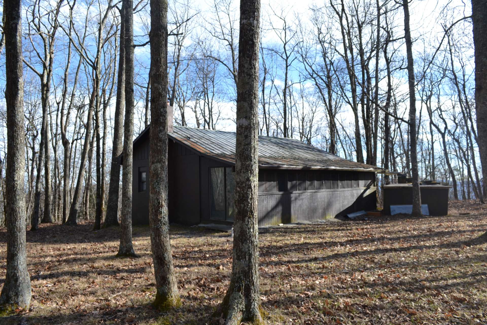 Hidden away beneath tall hardwoods, the modest 2-bedroom, 1-bath cabin is perfect for a rustic mountain retreat or hunting cabin for an off the grid experience.
