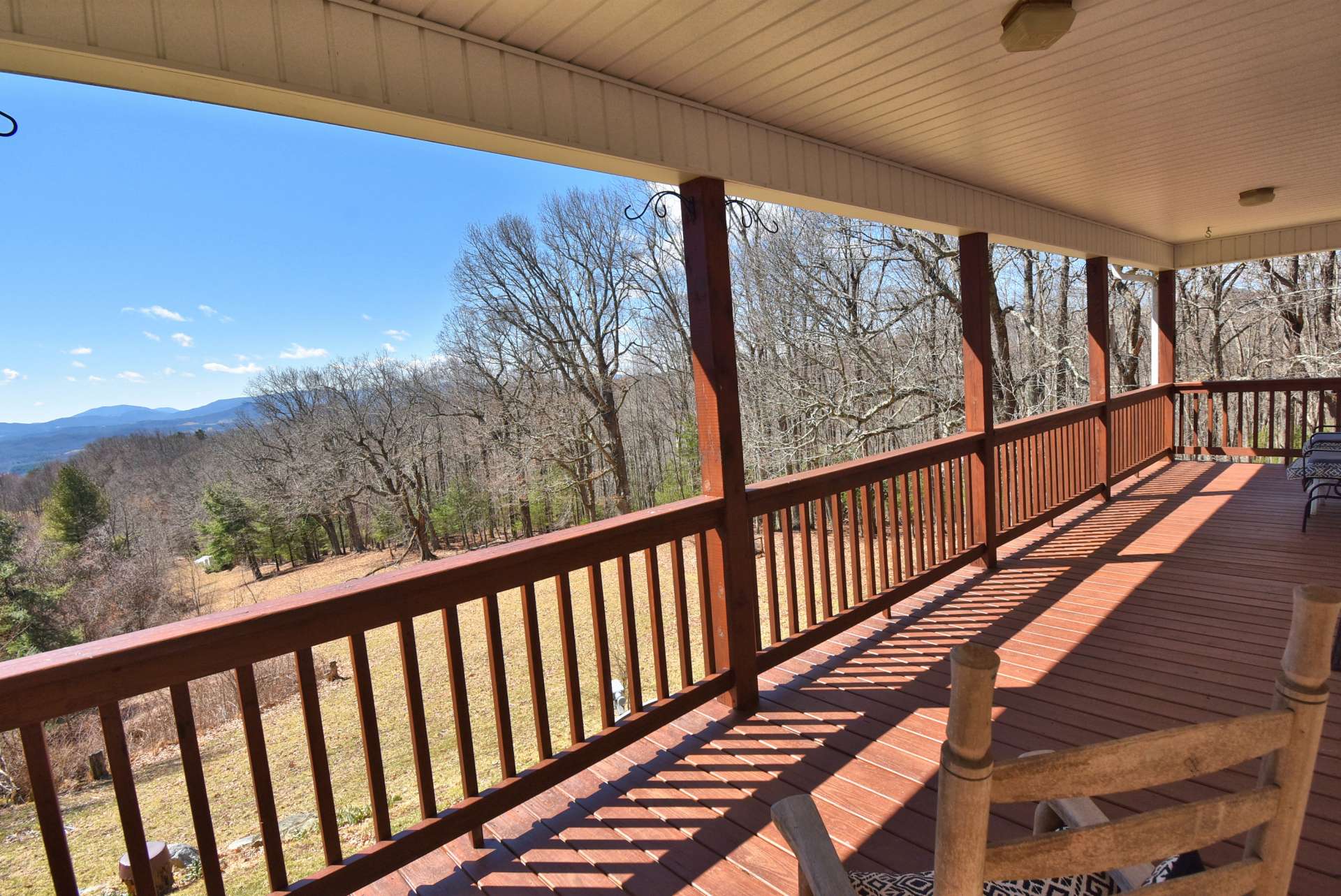 A full length covered deck is the ideal space to enjoy a tall glass of iced tea while enjoying the views, mountain scenery, and the sounds of Nature.