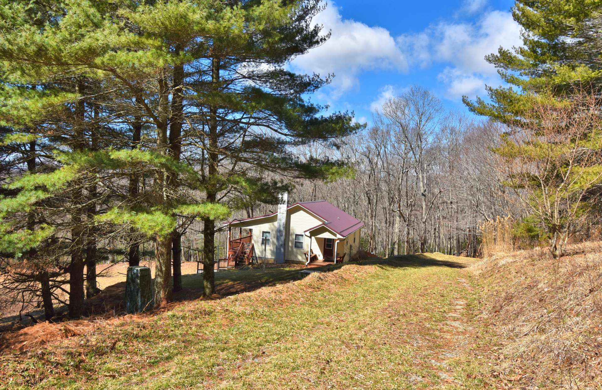 A private drive brings you to this cozy cottage hidden away on 6.95 acres.