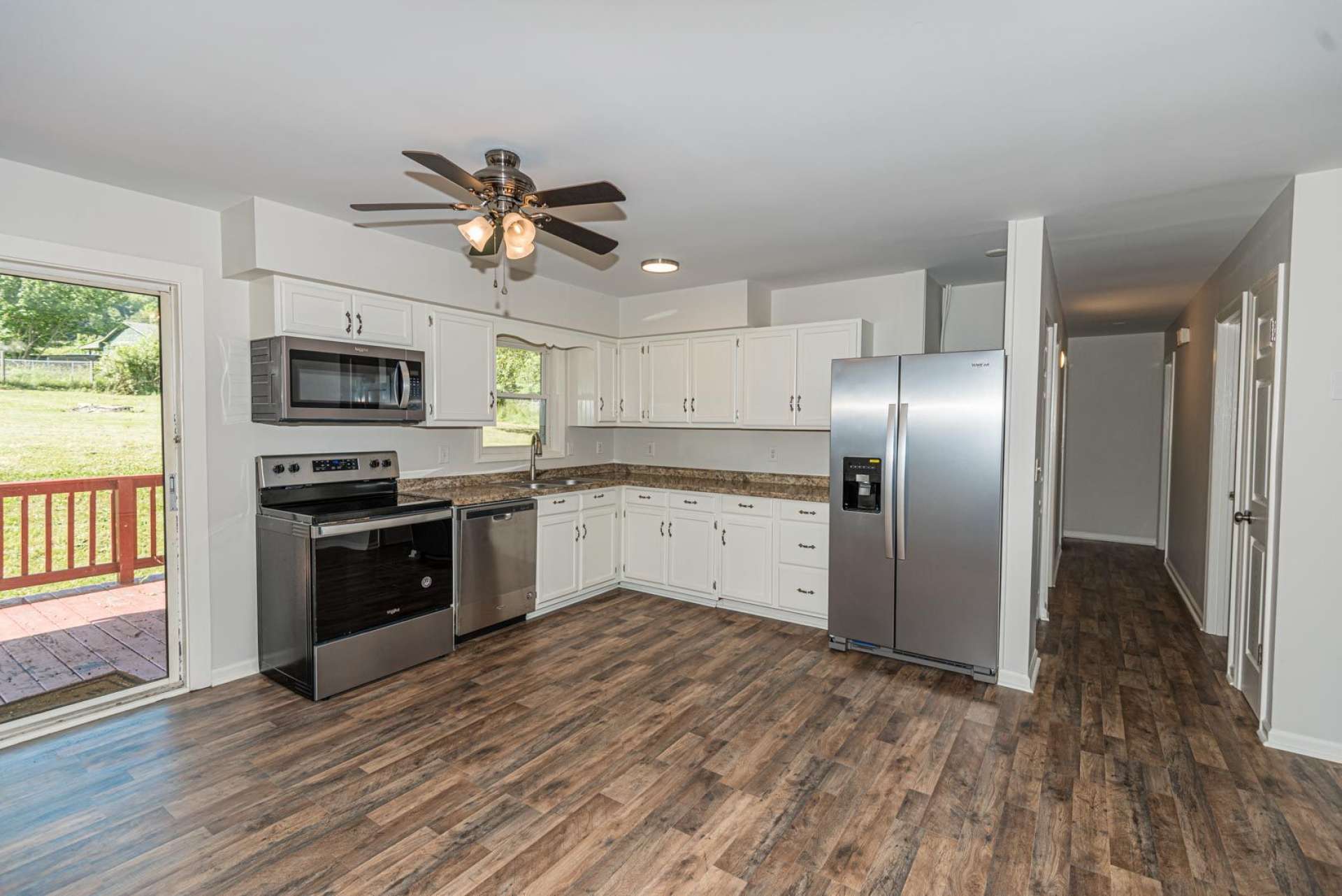 The efficient kitchen features all new stainless appliances and easy access to the back deck for alfresco dining.