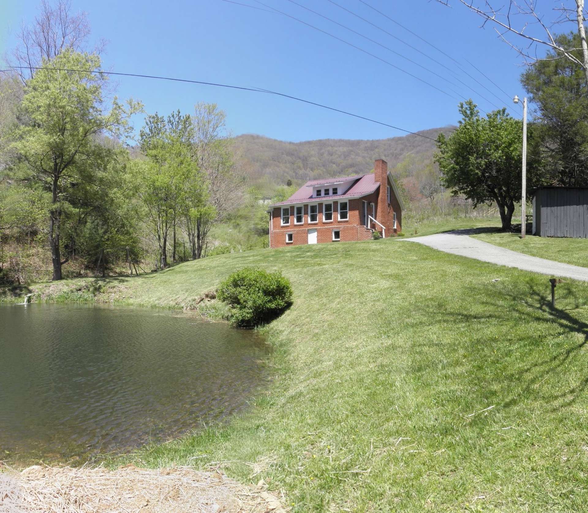 This sweet farmhouse nestled on a 2.68 acre setting with pond and mountain streams is located off of Ben Bolen road in the Creston area of Ashe County is offered at $189,900 and will serve nicely as your NC Mountain retreat or primary home.  O115