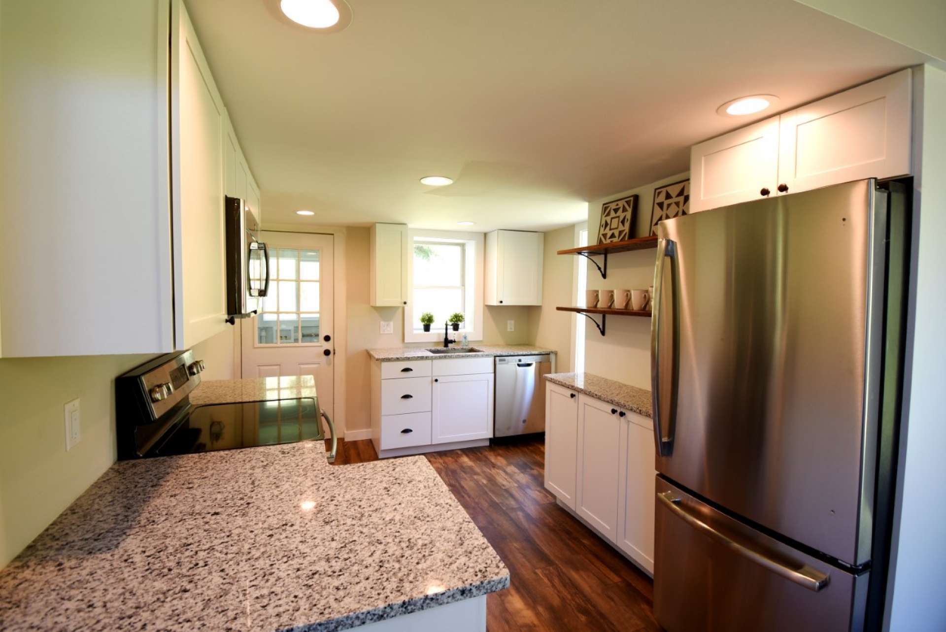 The kitchen features all new cabinets, granite counter tops, stainless appliances and under cabinet lighting.
