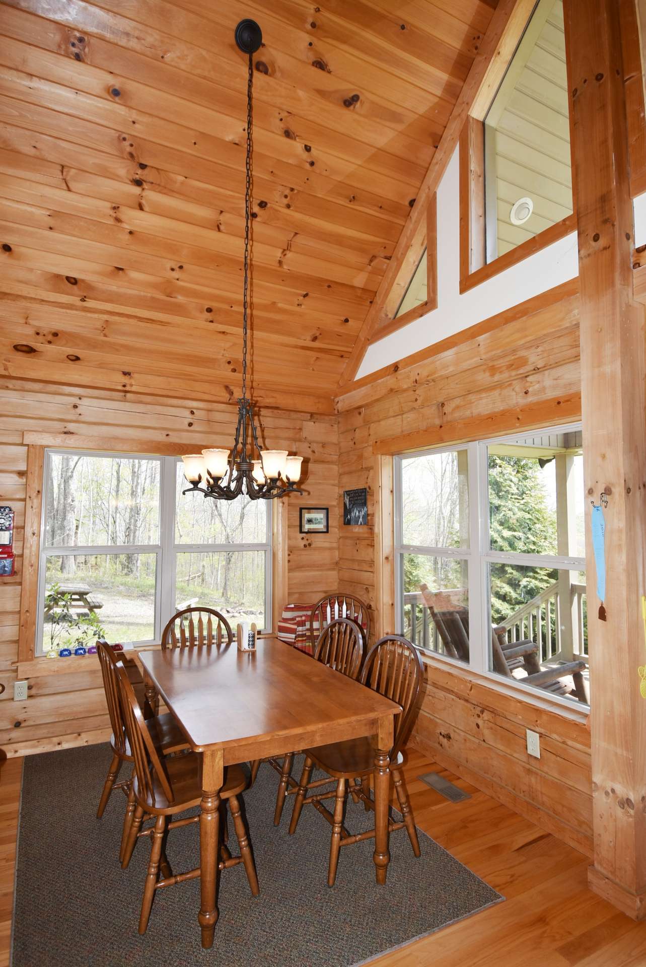 The vaulted formal dining area  embraces the outdoor scenery and views while dining inside.