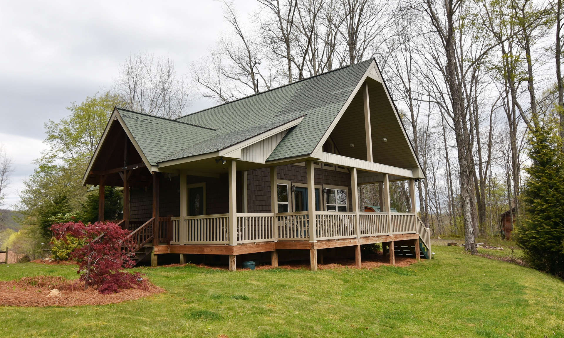 Country roads take you home to your  River Breeze log cabin with long range mountain views and cradled in a 3.73 acre setting in River Breeze Estates, a well established community offering common river access and located in the Creston area of Ashe County in the North Carolina Mountains.