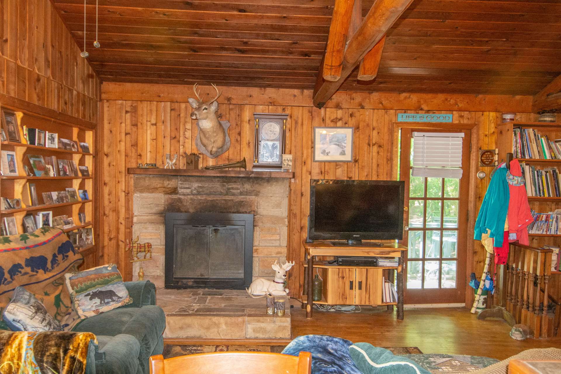 Vaulted living area with lots of warm wood and stone fireplace.