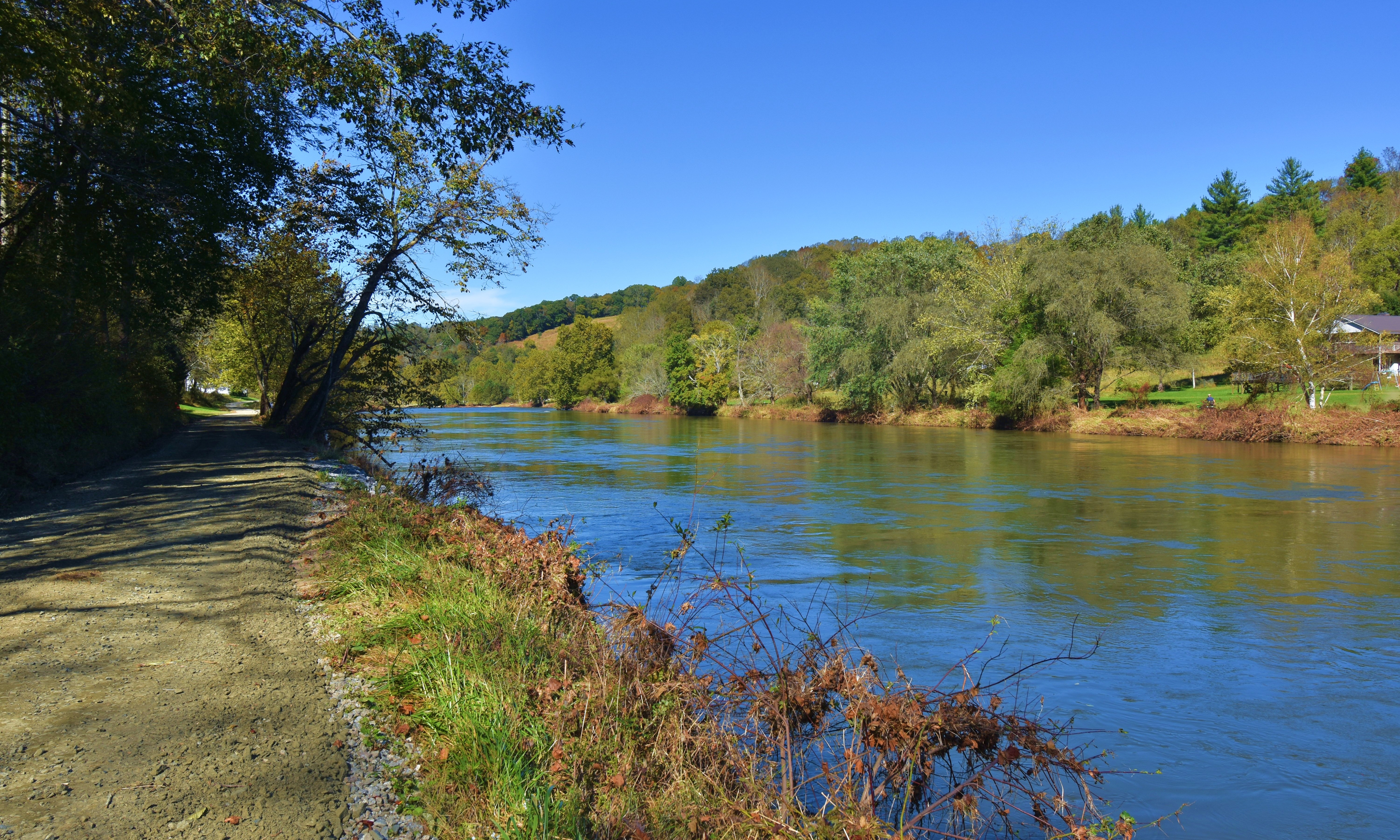 This approximately 40 acre tract is located  on a peaceful graveled country road that runs along side of the South Fork of the New River in the Crumpler area of Ashe County in the NC Mountains.