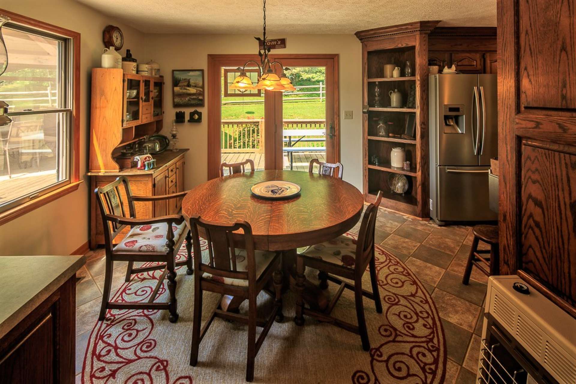 The kitchen also offers a breakfast nook or informal dining area featuring easy access to the outdoors.