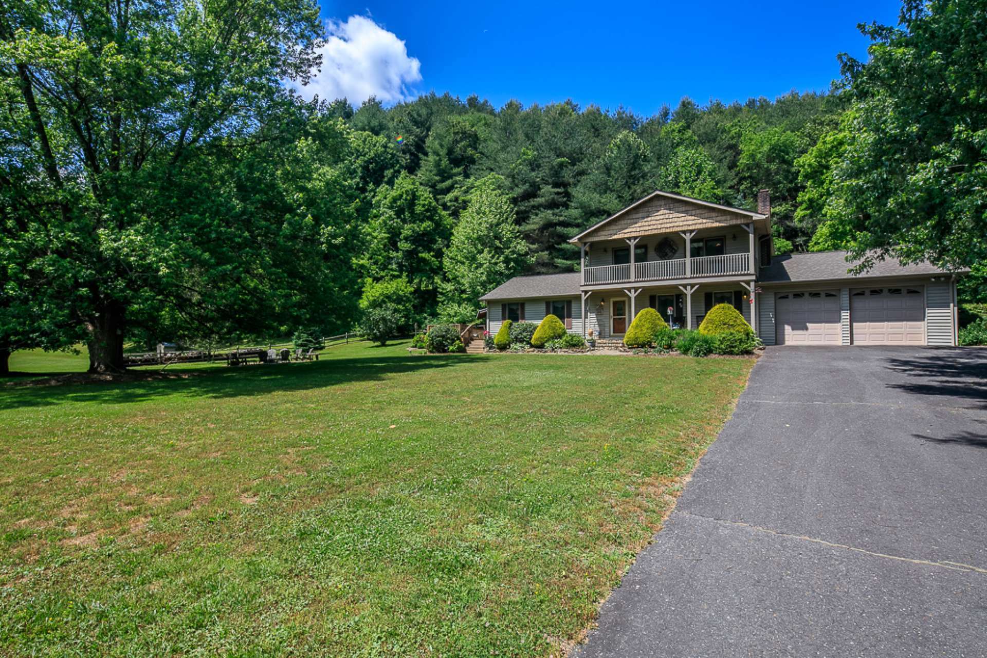 From the balcony, you get another prospective for the beautiful setting and peaceful surroundings. Notice the outdoor firepit area where new memories are made and old memories shared.