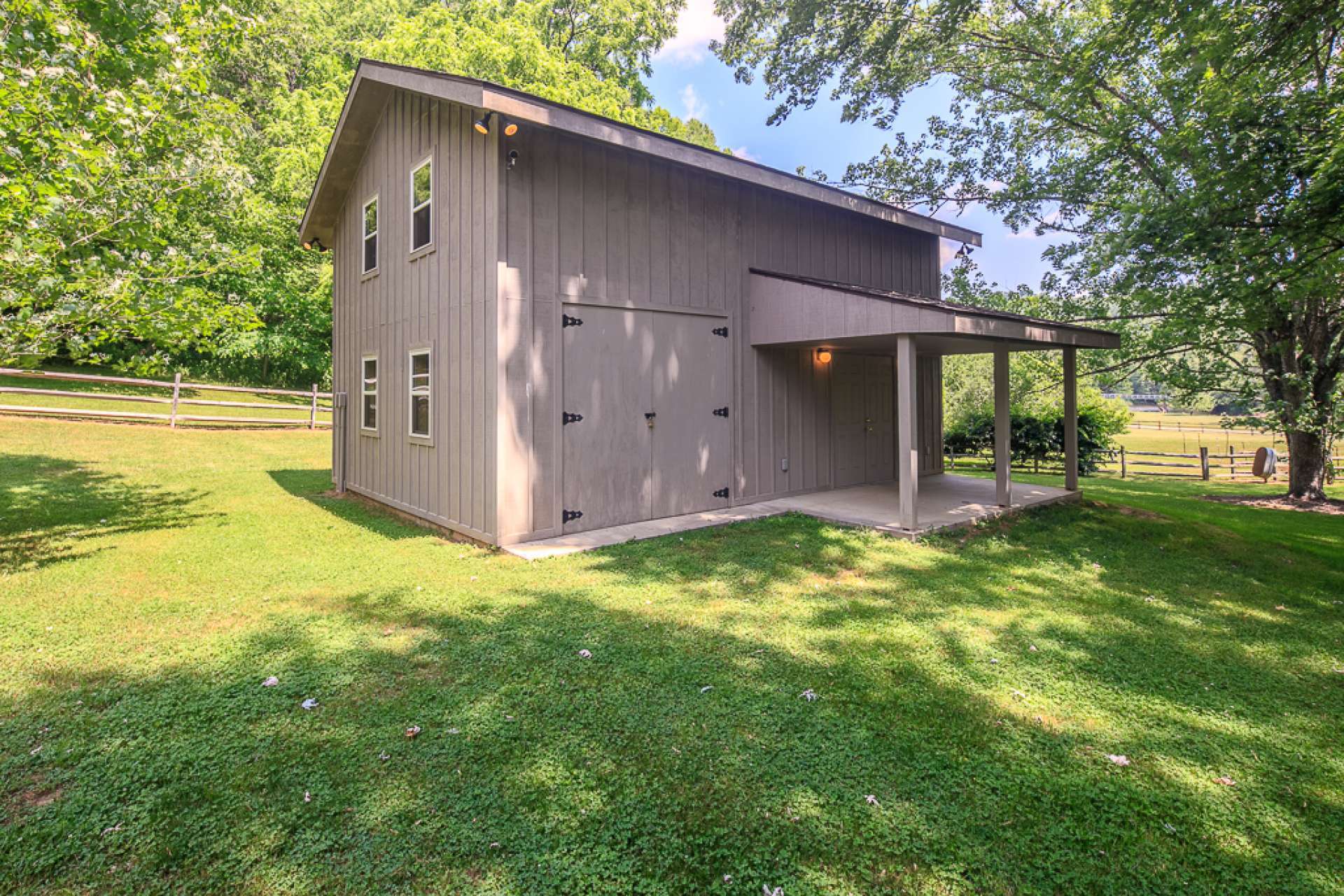 A 20' x 28' board and batten workshop/garage is heated and wired, with a concrete floor and plenty of storage above.