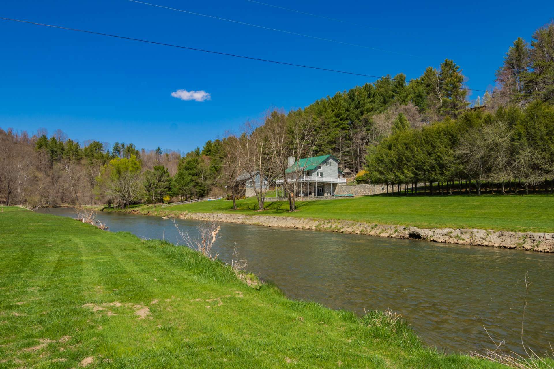 This adorable and affordable 2-bedroom, 1-bath log cabin on the banks of the North Fork of the New River is offered at  $179,900. Call today for additional details on listing D179.