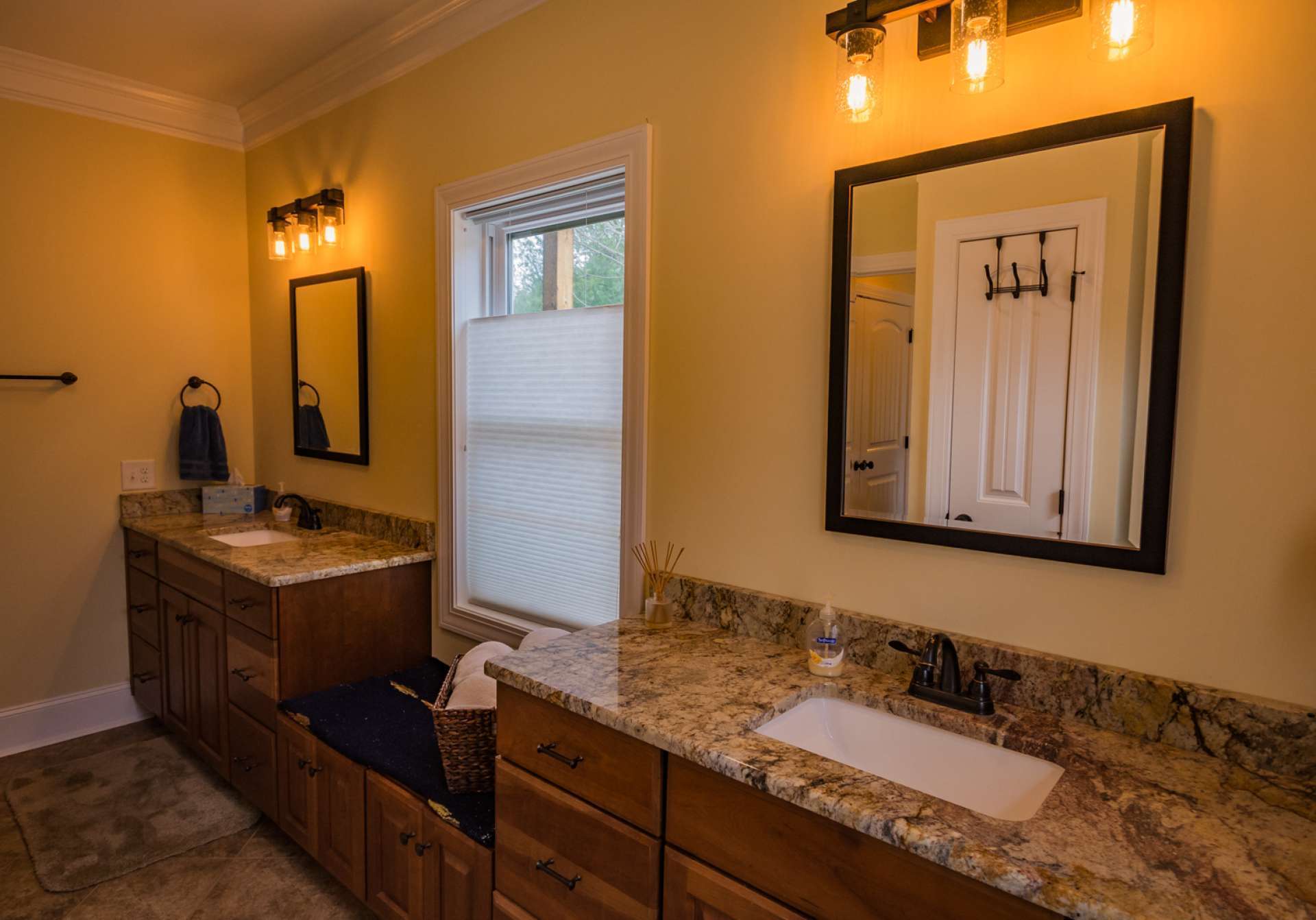The luxurious master bath features Kraftmaid double vanities with granite tops, a tiled shower and walk-in closet.