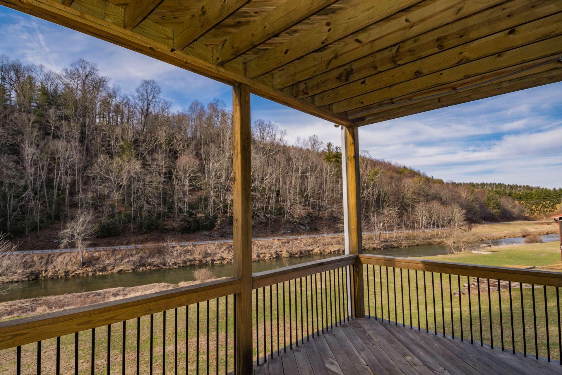 Relax on the covered back decks and enjoy the New River as it slowly flows by the back lawn.