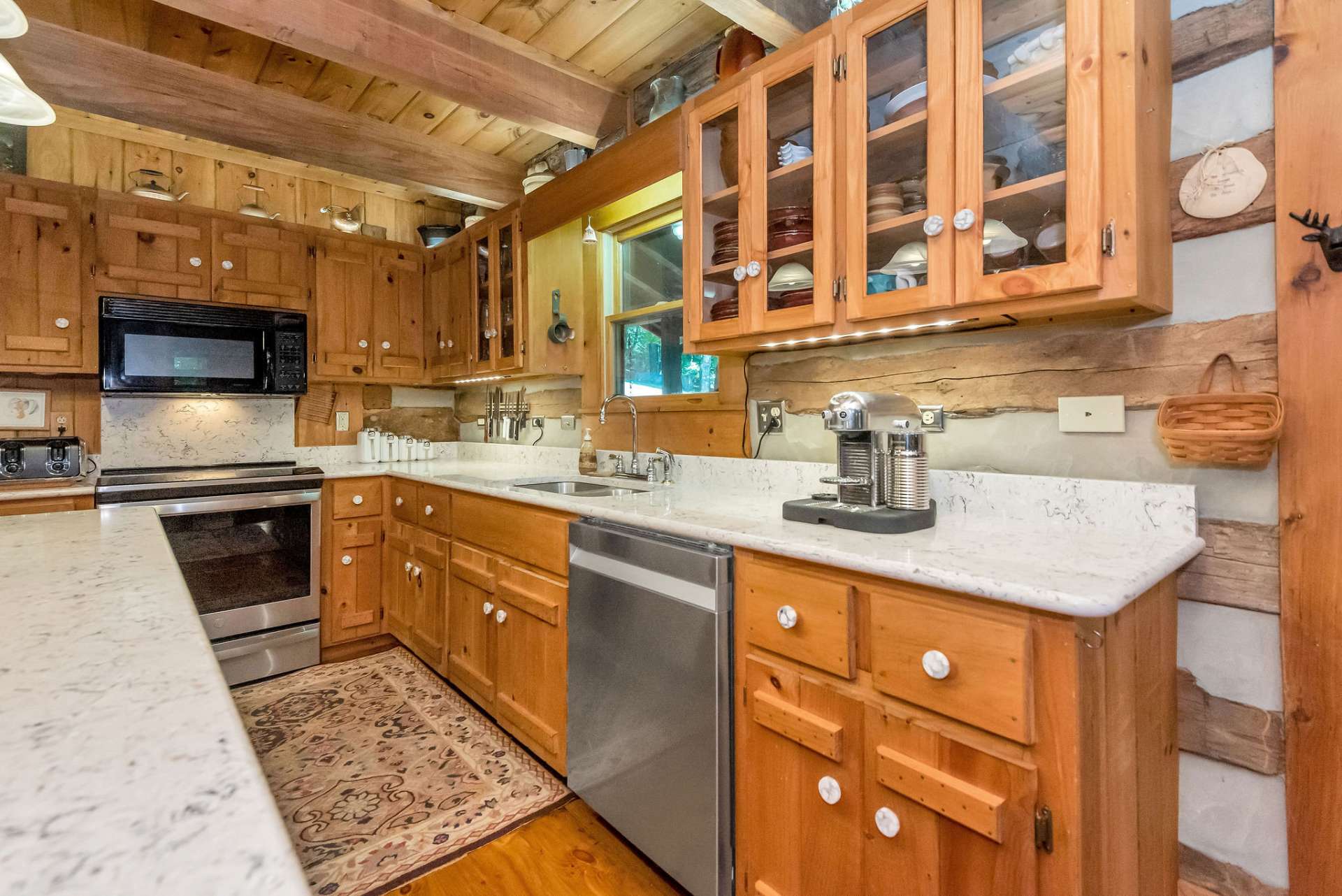 Abundant storage in the handcrafted cabinets. The glass doors add variety and a modern flare.