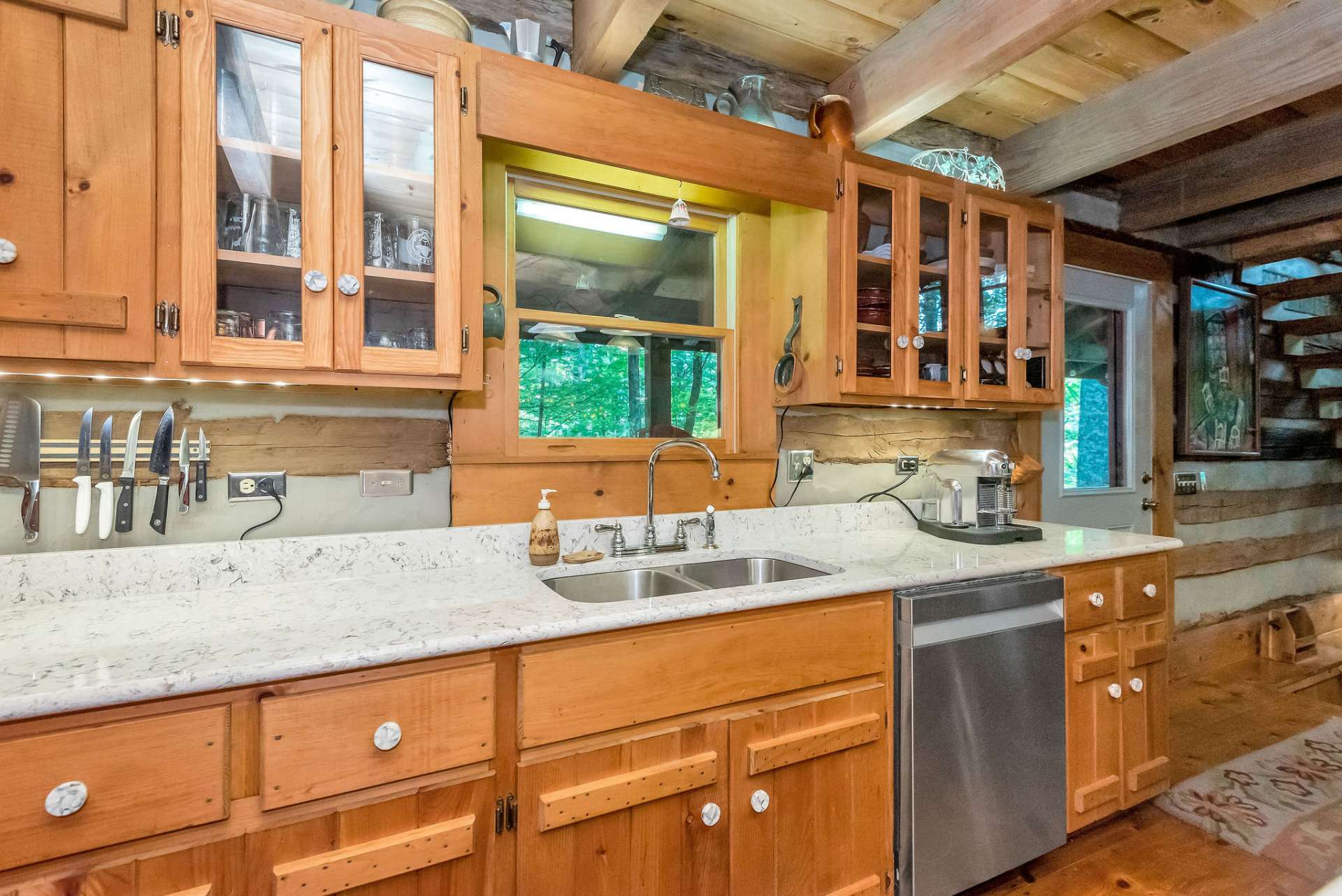 The light granite countertops beautifully contrast the warm wood tones.