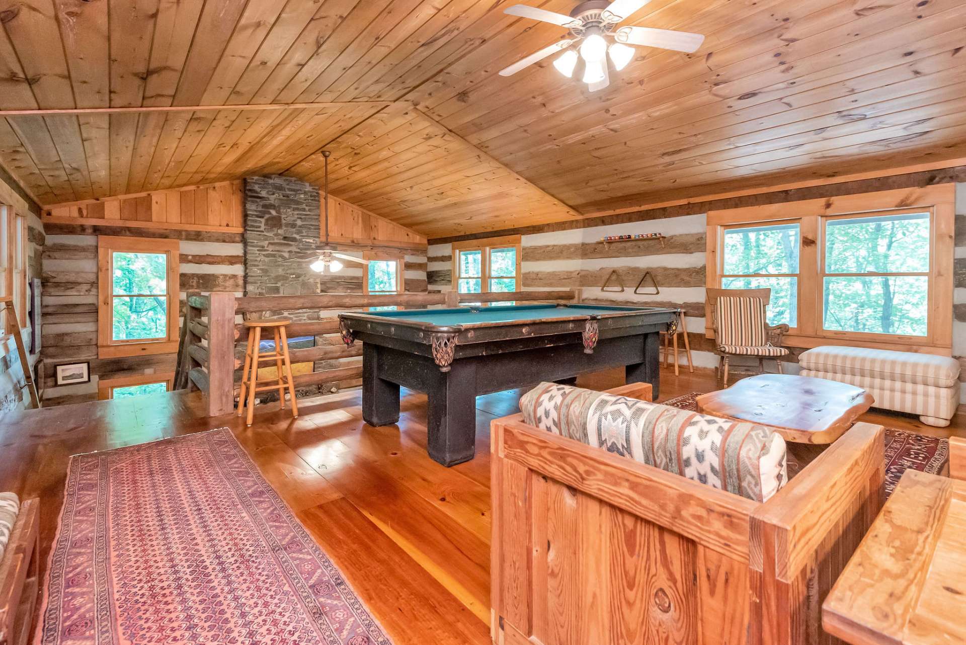 The loft offers a vaulted ceiling and windows all around.