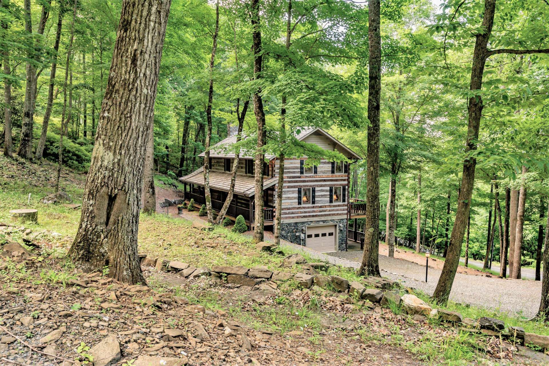 This beautiful cabin sits on a one acre park-like setting in Stonebridge, one of Ashe County's most sought after log home communities.