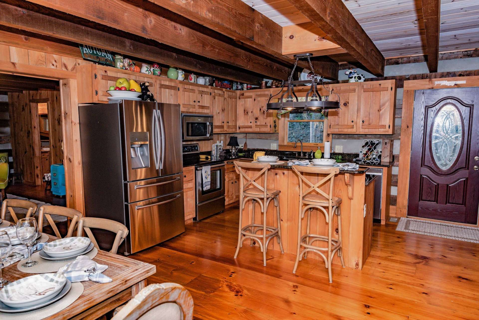 The well equipped kitchen has stainless steel appliances, granite countertops and center island.