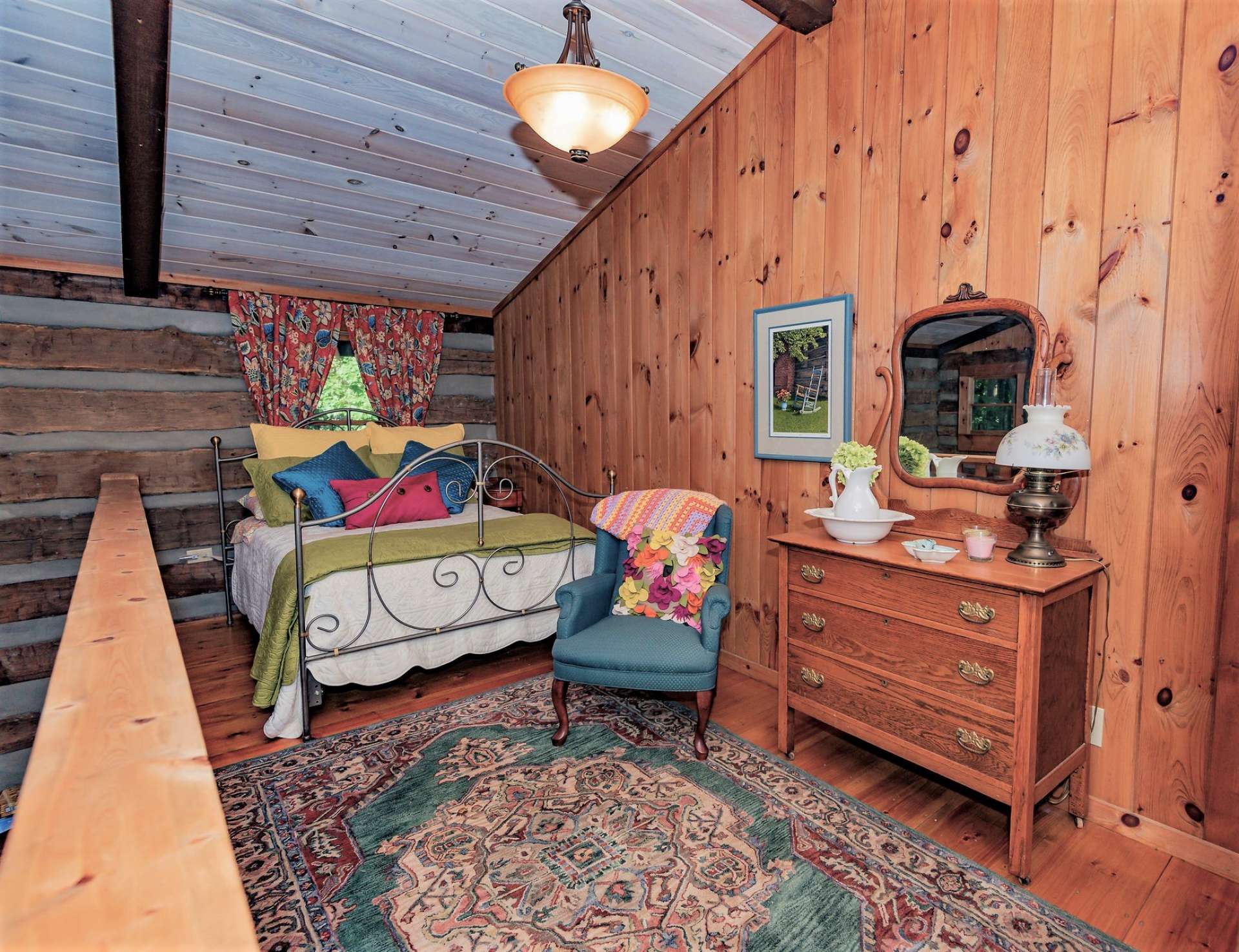 This open loft is currently used for extra sleeping and cozy reading nook.