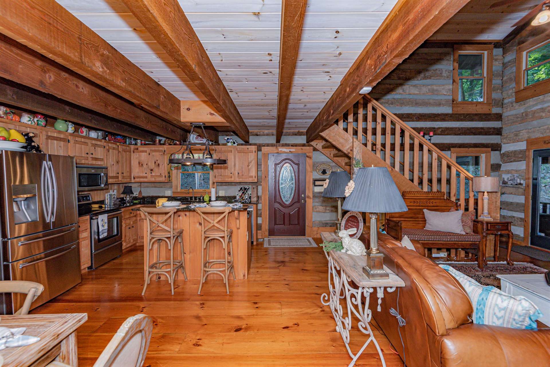 You are greeted with an open floor plan offering an invitation to explore the cabin.