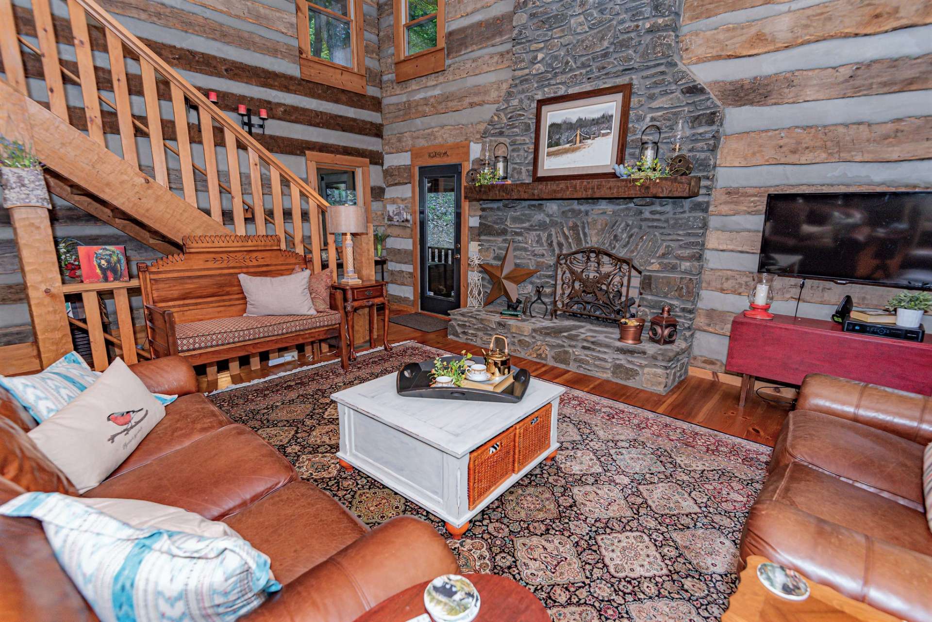 The soaring stone fireplace equipped with gas logs reaches to the cathedral ceiling and is the focal point of the great room.