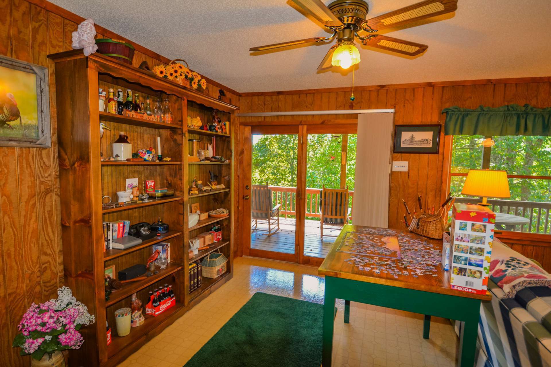 Notice the built-ins for displaying your favorite collectables, books, or family photos. You will also enjoy easy access to the deck for outdoor grilling, dining, and entertaining.