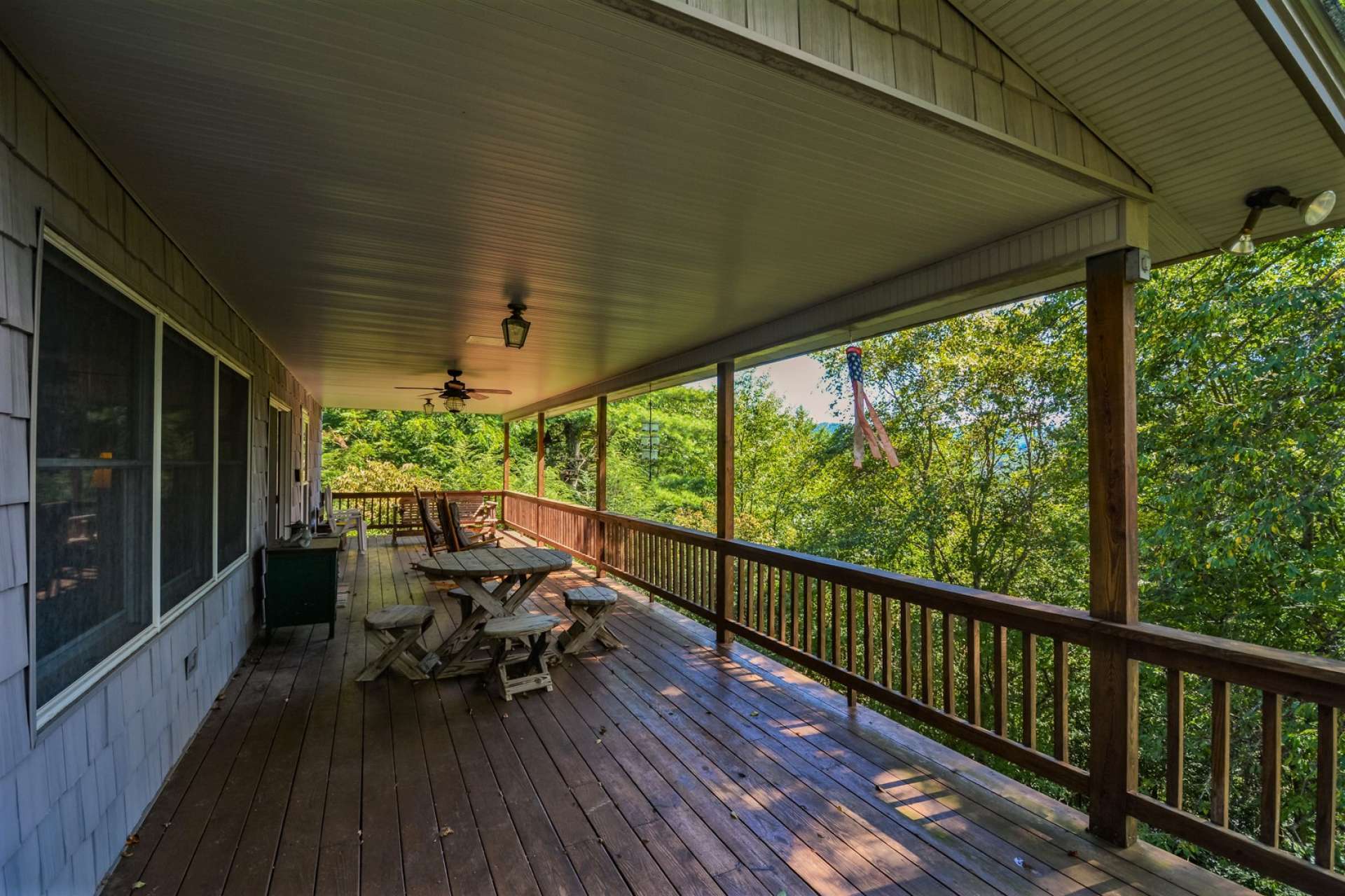Relax on the long covered back deck and enjoy the wooded surroundings  and the gentle mountain breezes whispering through the trees.
