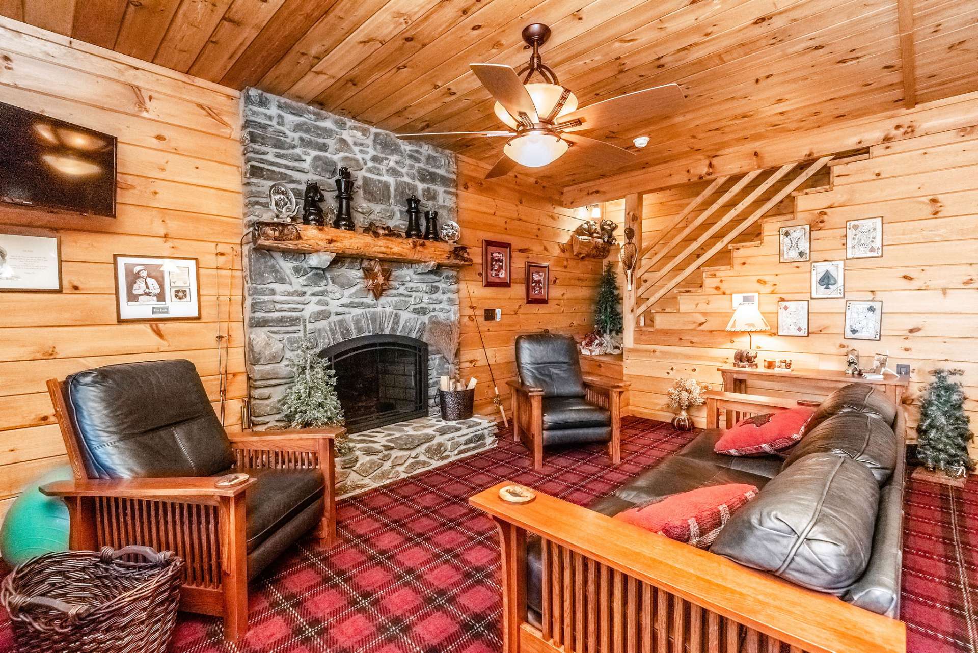 Lower level den with the second stone fireplace, this one with gas logs, and another hand carved mantel to sit and marvel.