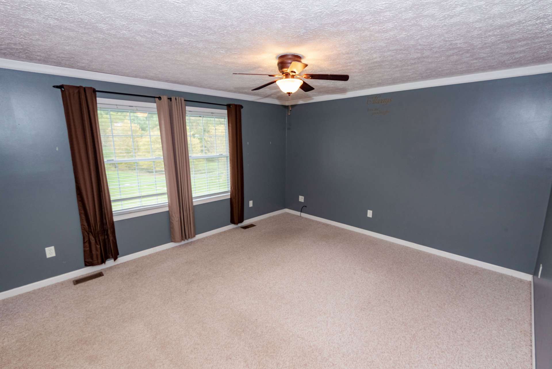 Master bedroom has a view of the back yard.