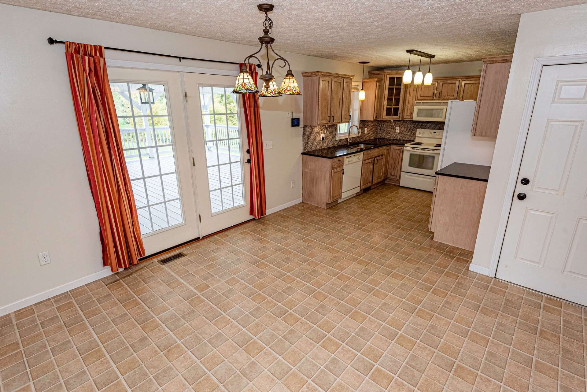 Kitchen and dining room combo opens to covered porch.