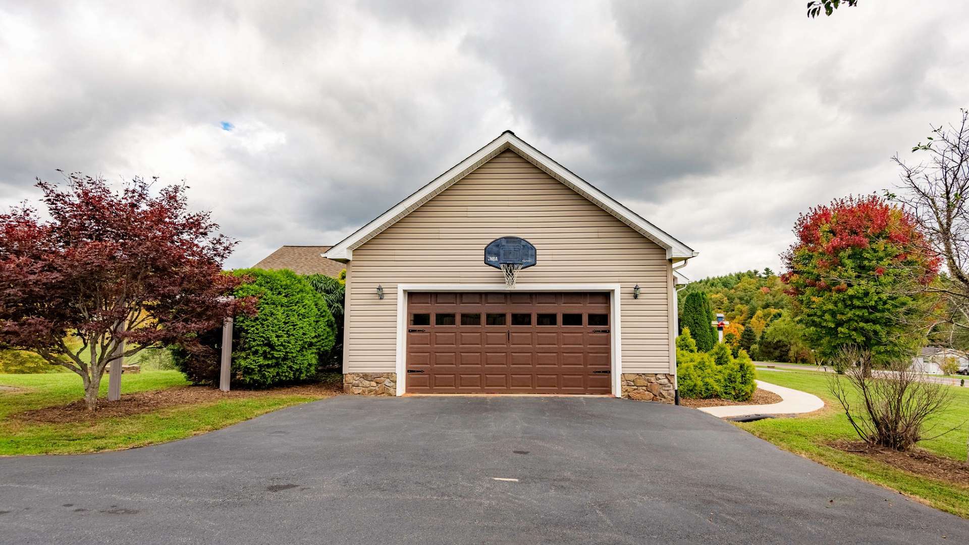 Top paved driveway brings you into the one car attached garage, and it even has a basketball goal.