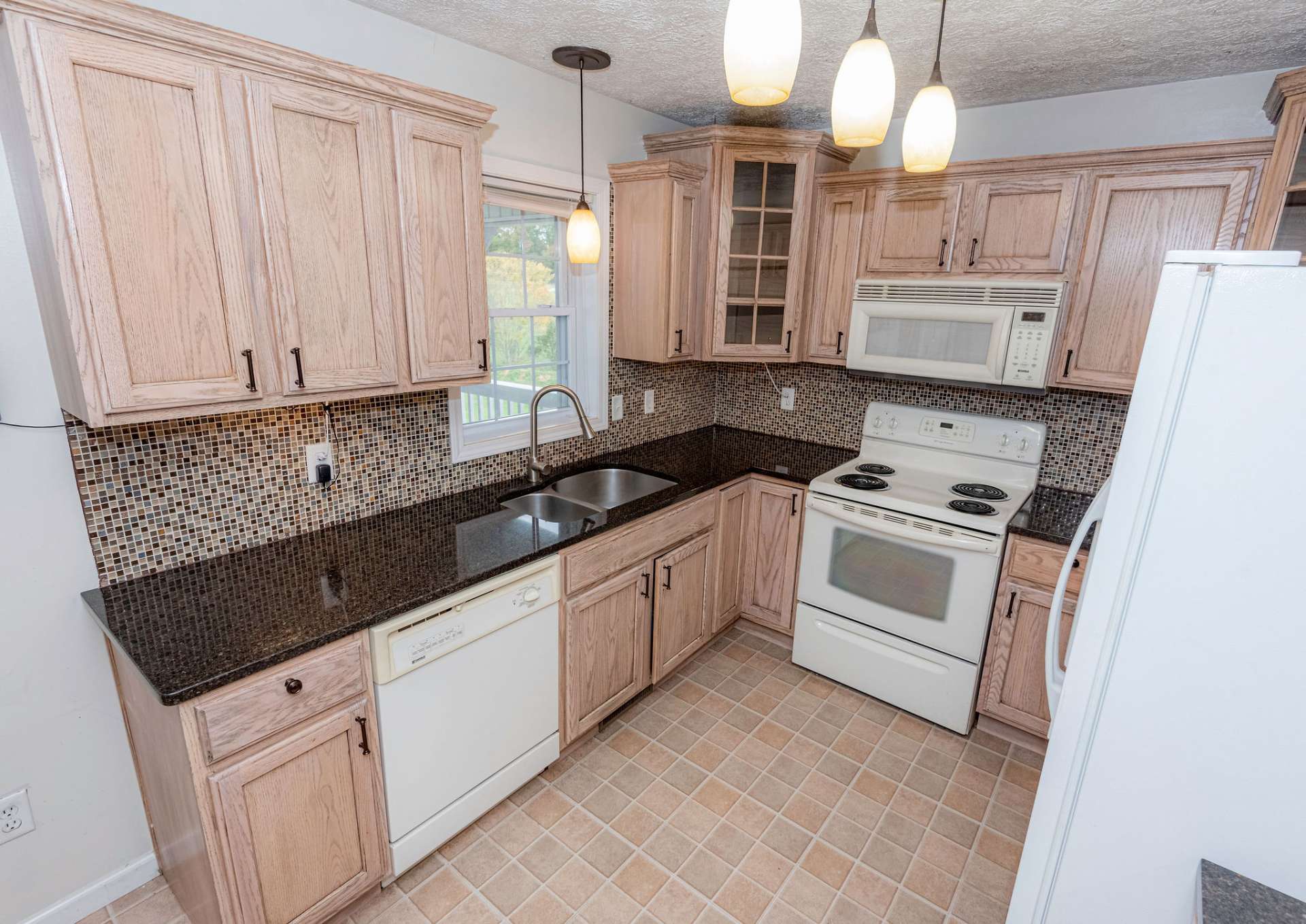 Quartz countertops and oak cabinetry.