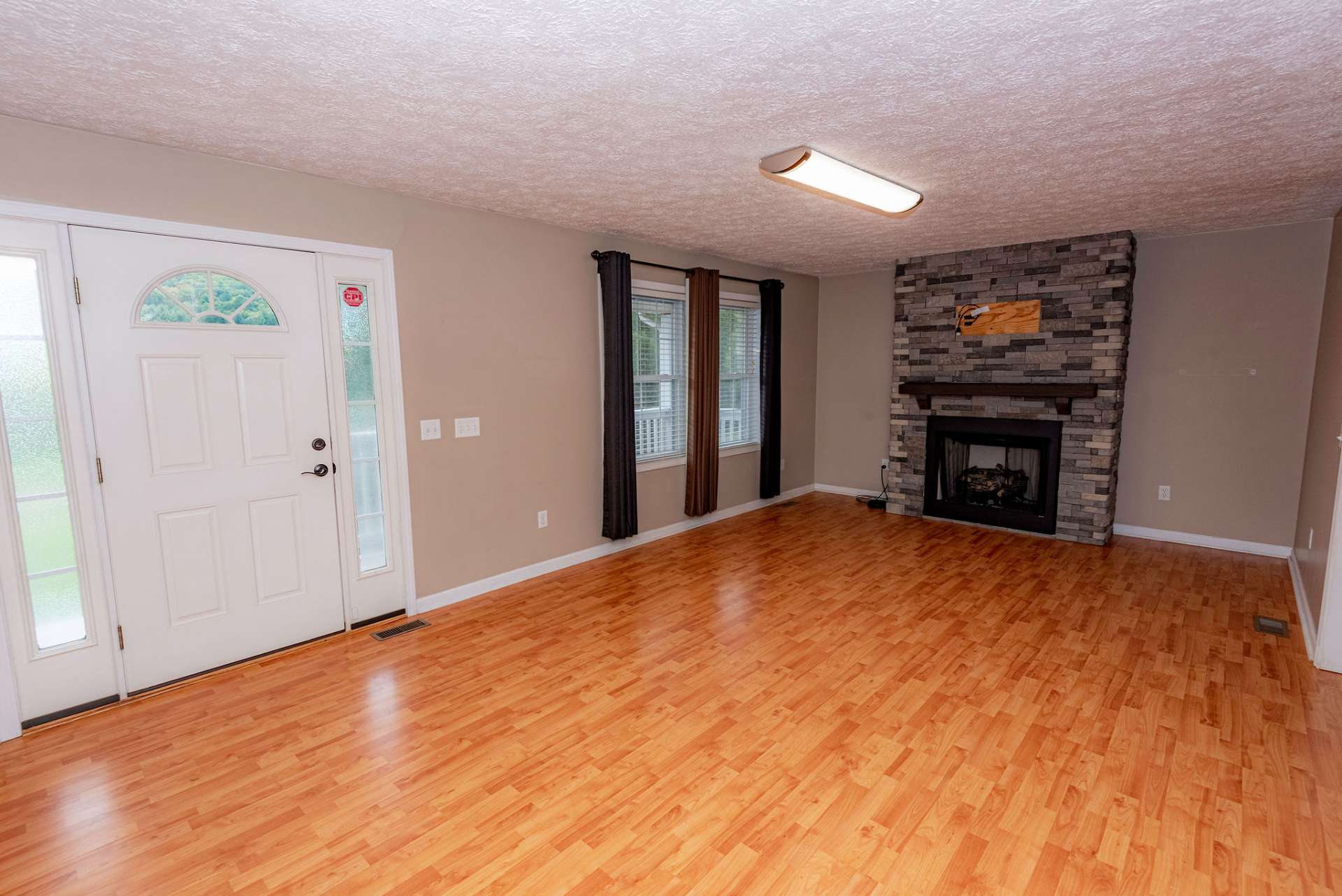 Walk in the front door to the living room with a gas log fireplace.