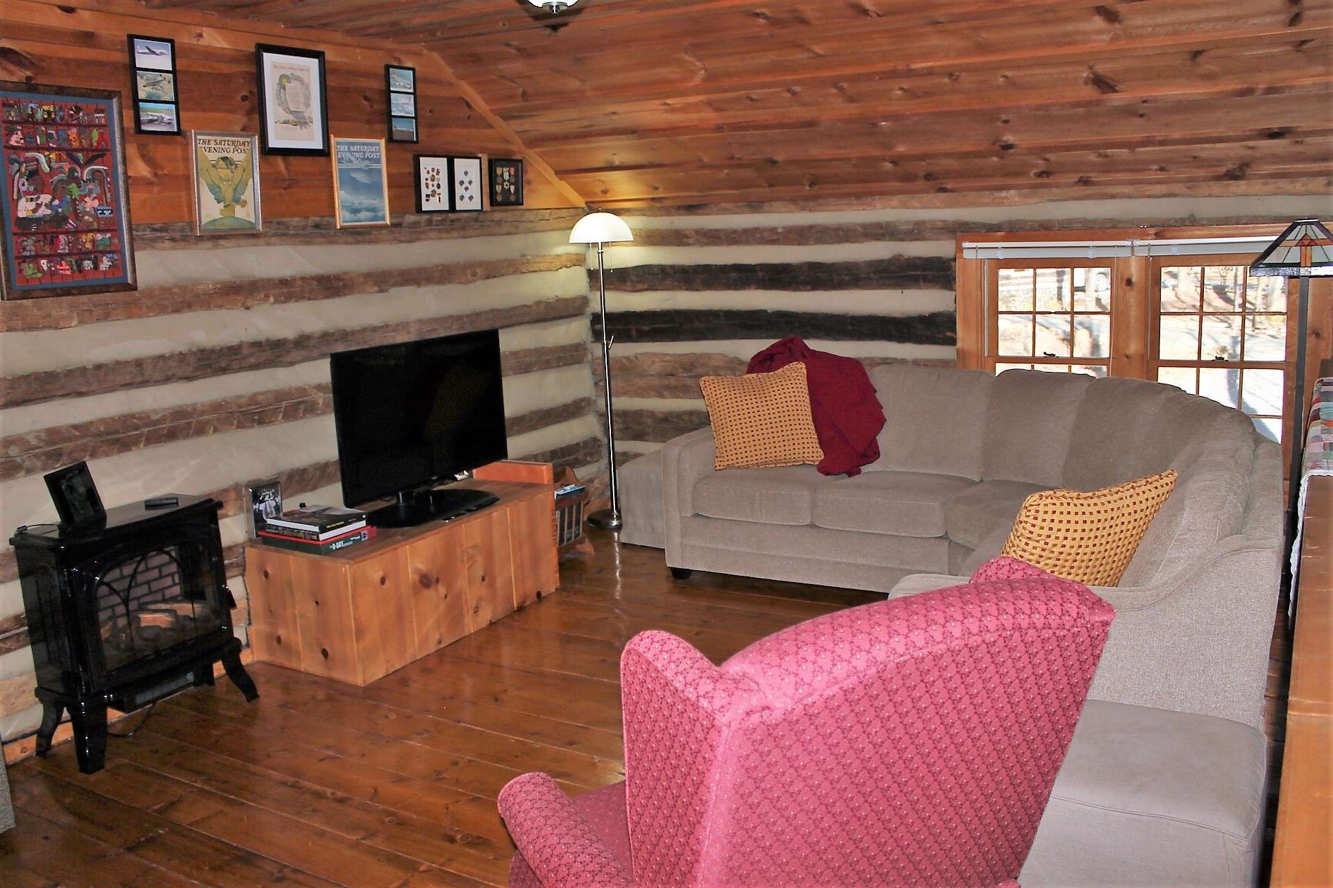 Open loft is currently being used as a TV and game room and has an electric fireplace for added comfort.