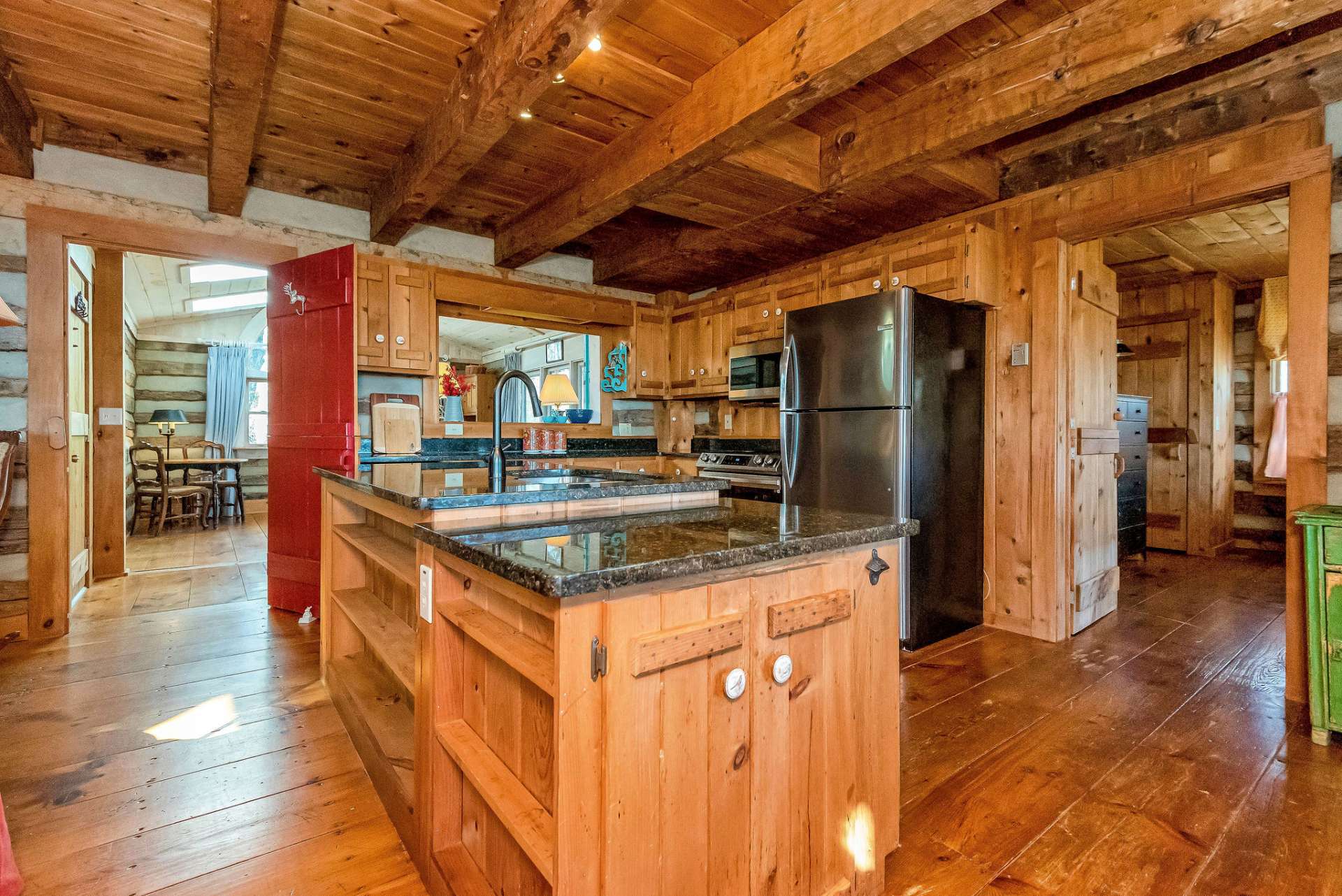 The sturdy hand-hewn beams and wide plank flooring amplify the rustic mountain charm.