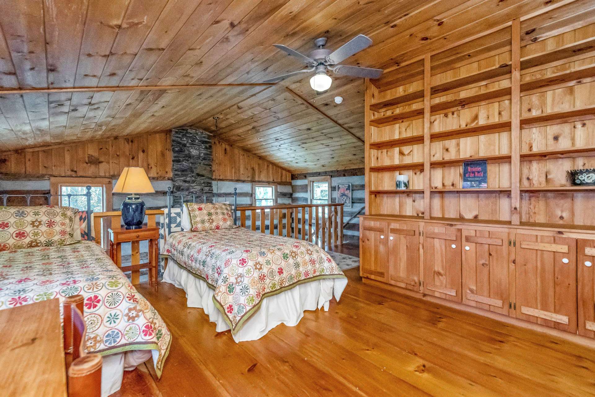 The open loft could also serve as a library/study space with the custom built-in book shelves and desk.