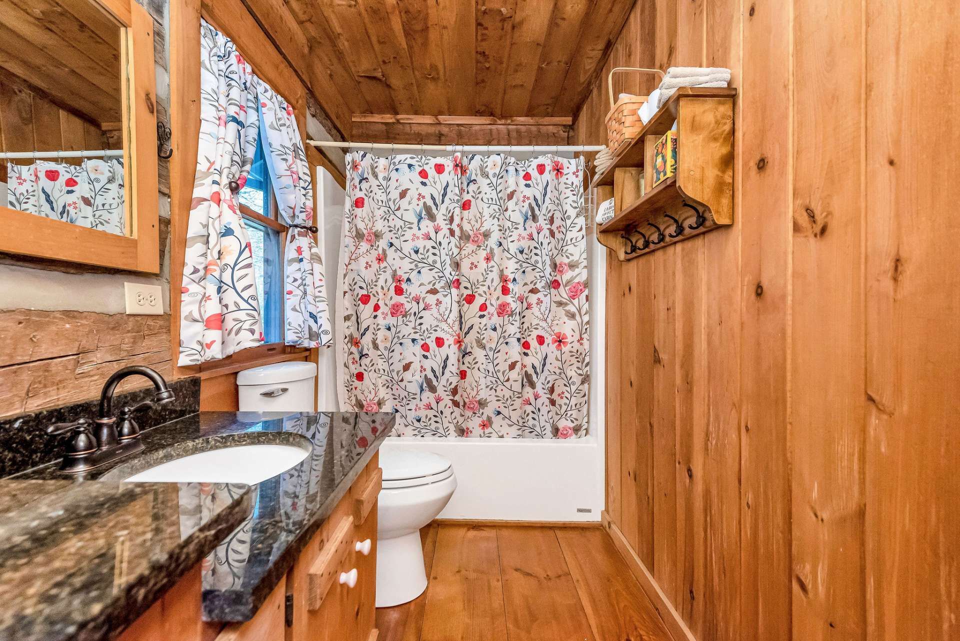 This primary bath with granite countertops, double sinks, and a tub-shower combo offers both functionality and elegance.