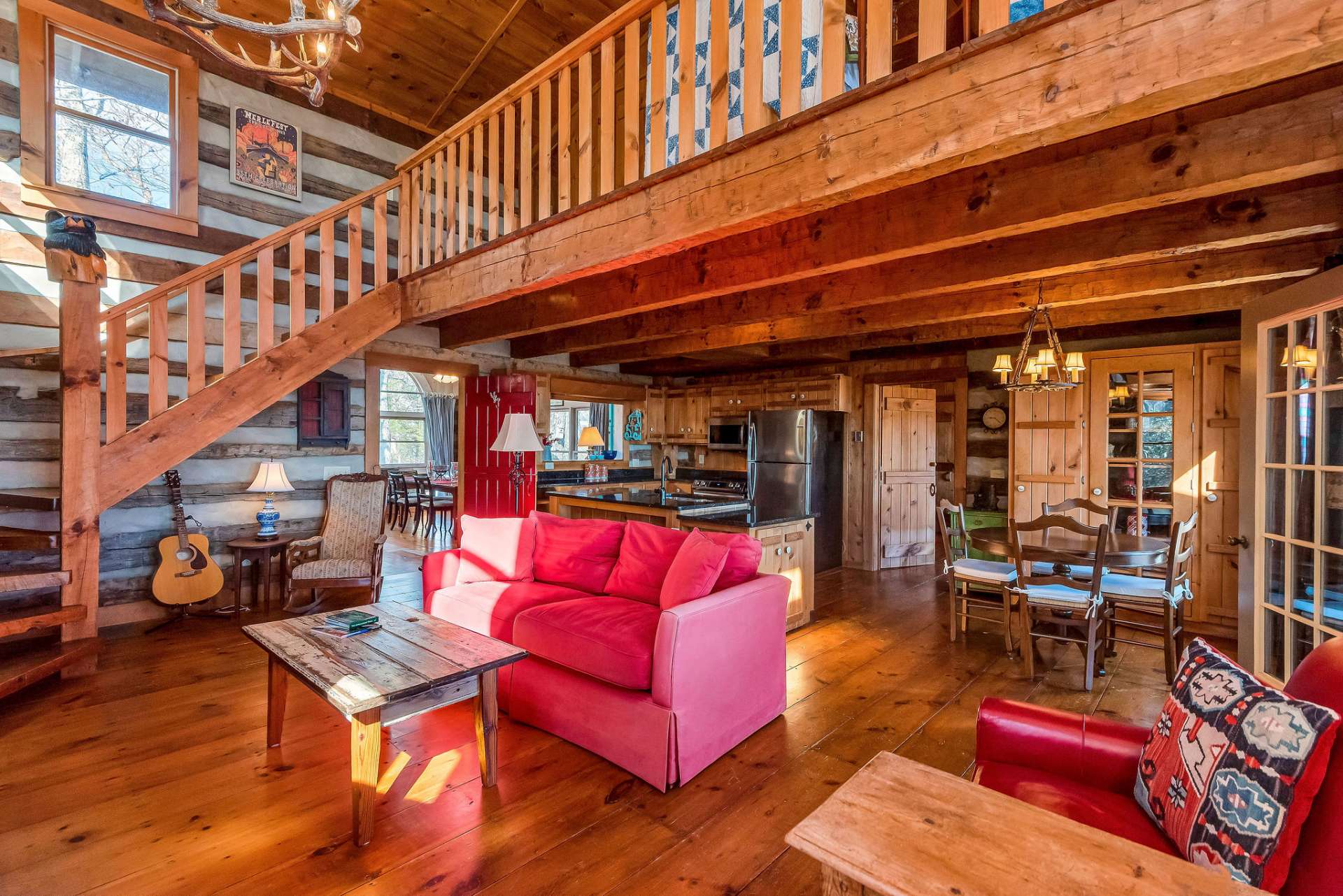 The hand hewn stairway leads to an open loft with an additional full bath and a laundry closet.