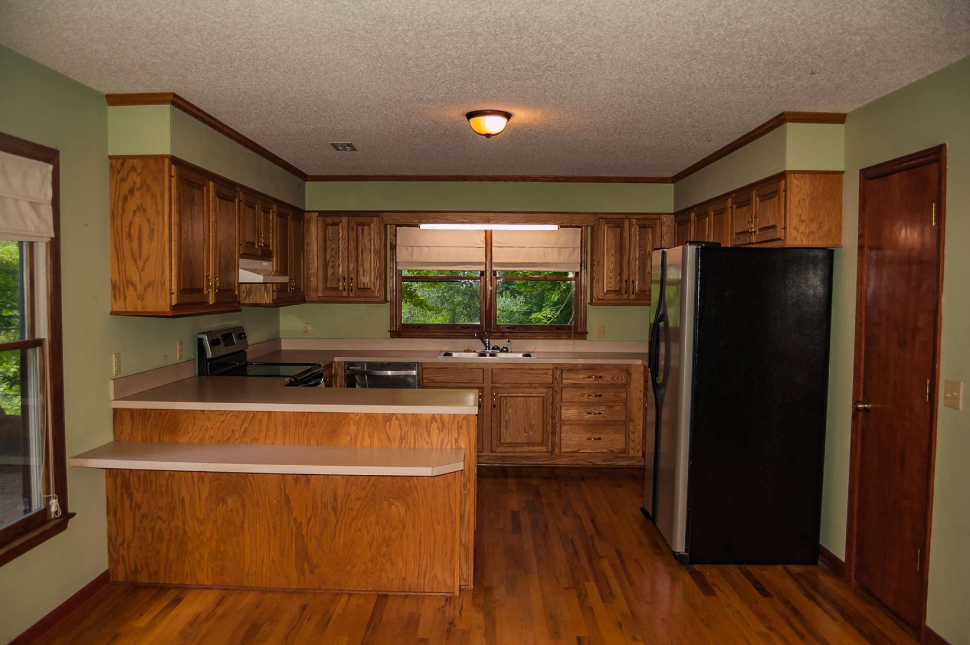 A step saving and efficient kitchen features plenty of work and storage space including a bar with seating space.