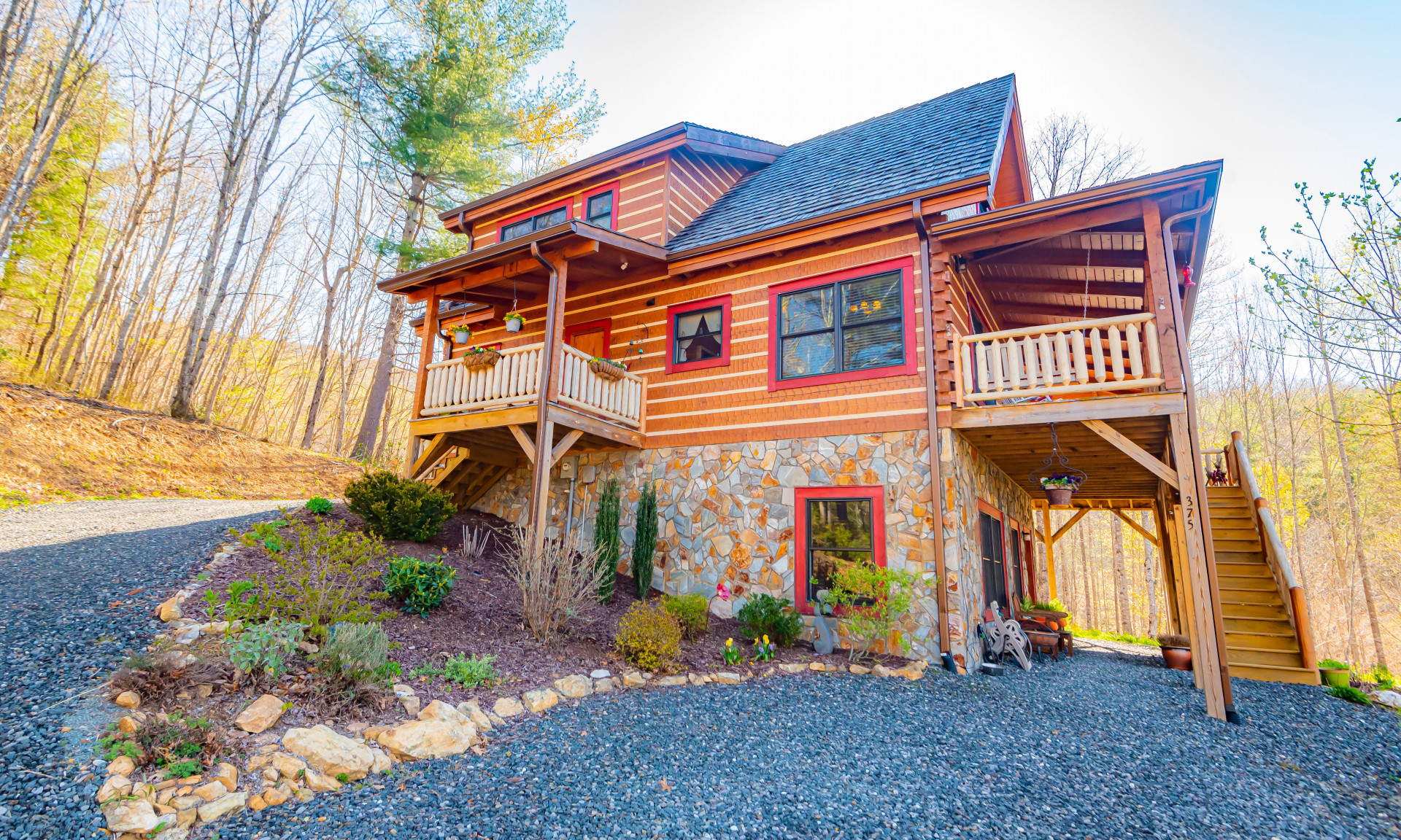 This 3-bedroom, 3.5-bath log cabin is majestically situated on a 2+ acre wooded setting in the Christmas Mountain community located in the Fleetwood area of Southern Ashe County.