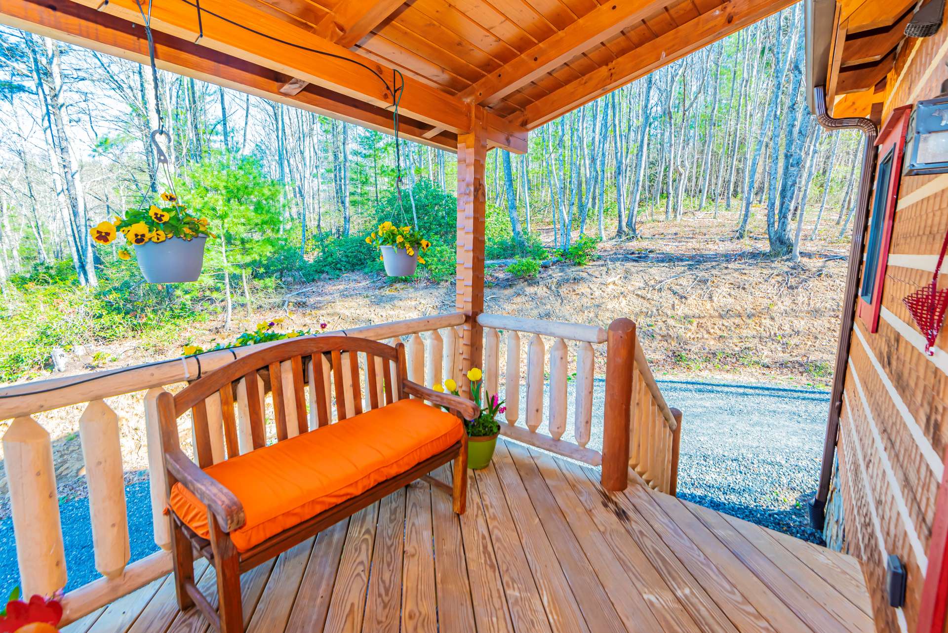 A sweet covered porch welcomes you to sit and relax with the sounds of Nature all around you.