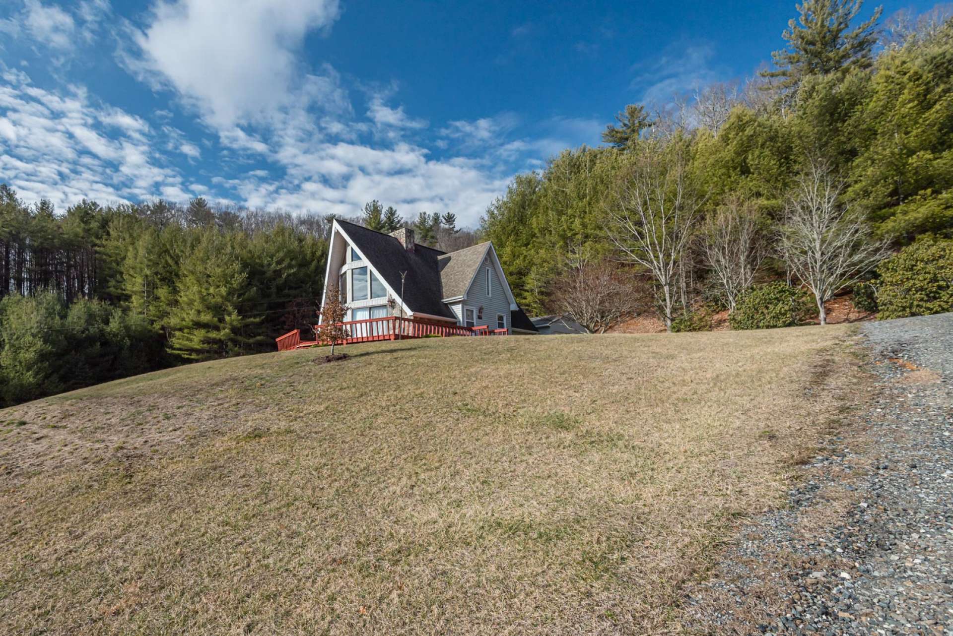 In addition to the convenient location and beautiful acreage, this home offers gorgeous long range mountain views that can be enjoyed from the open deck and many locations of the property and inside the home.